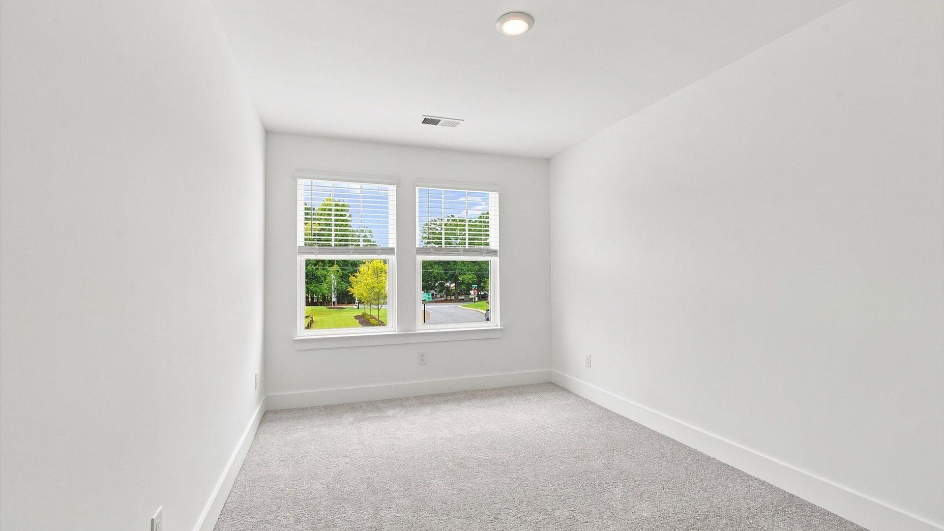 Refined bedroom design with large windows for daylight-filled mornings and peaceful views in Spartanburg, SC