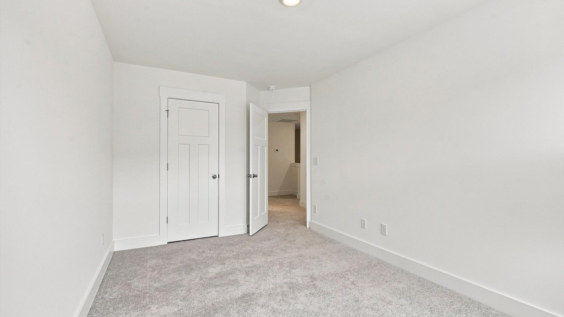 Vibrant and inviting secondary bedroom featuring a walk-in closet and refined finishes