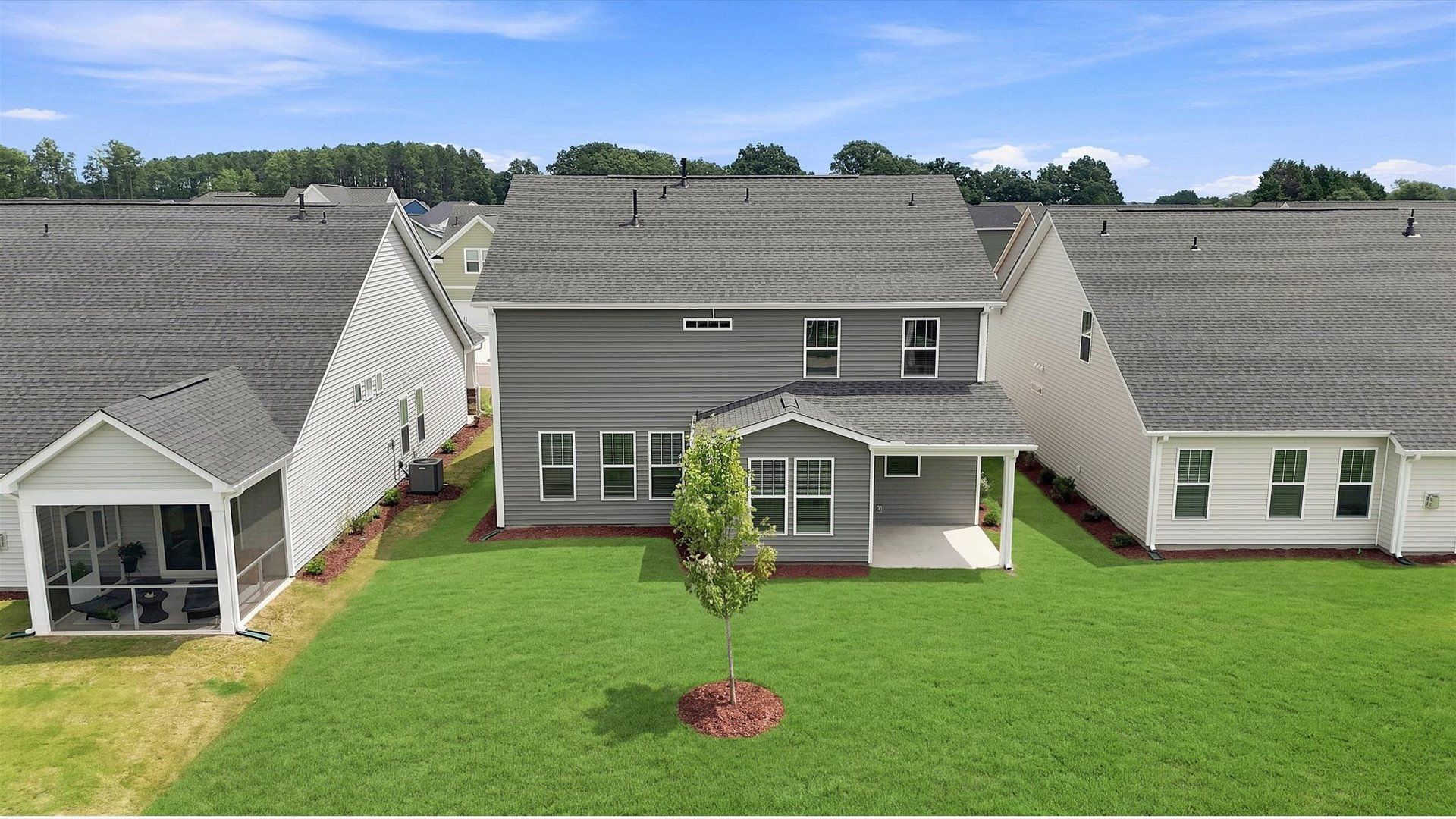 Exceptional outdoor living begins with a covered back porch in this thoughtfully designed home at Walnut Ridge