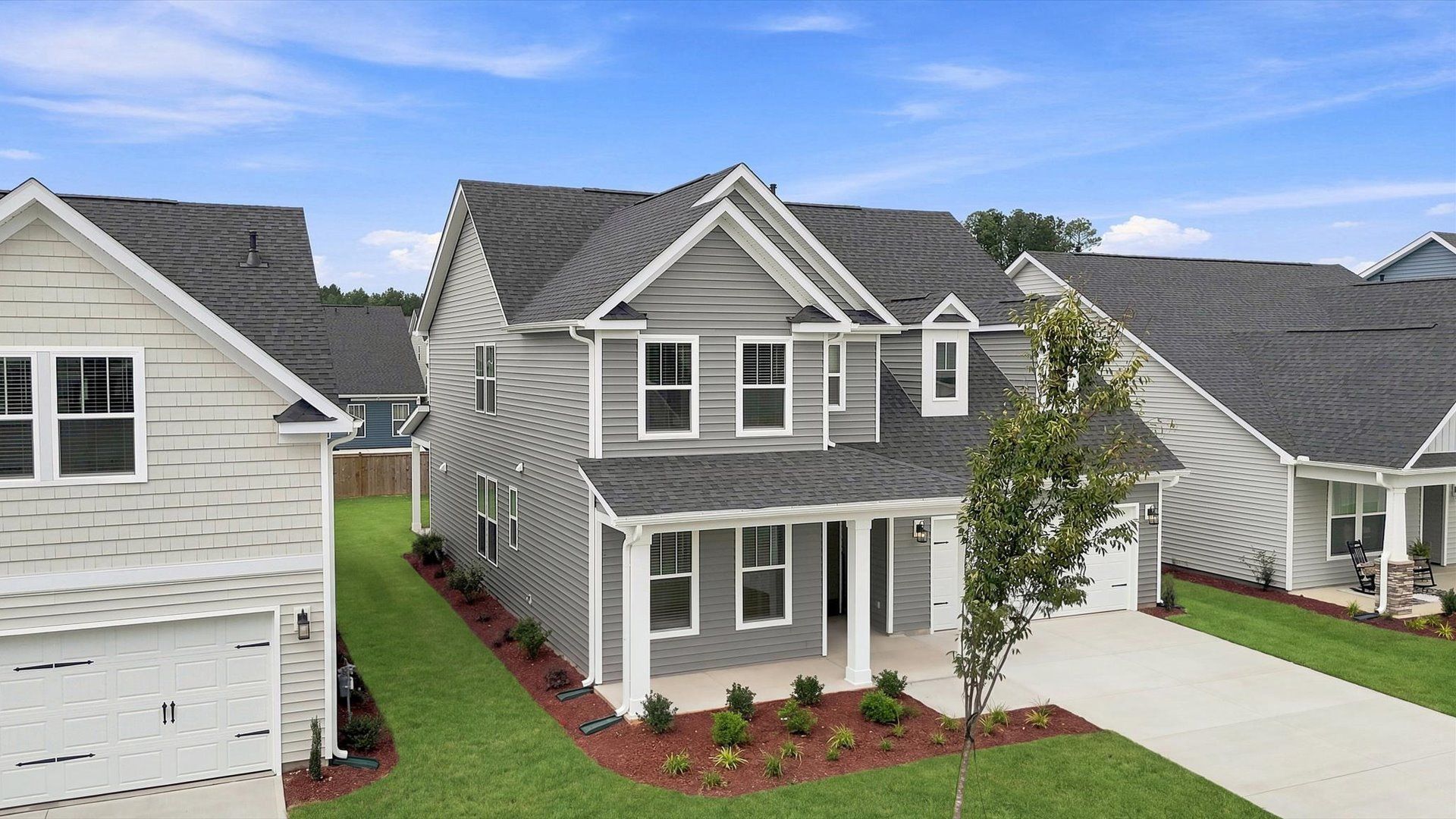 Vibrant home exterior in a thoughtfully planned community near city conveniences by DRB Homes