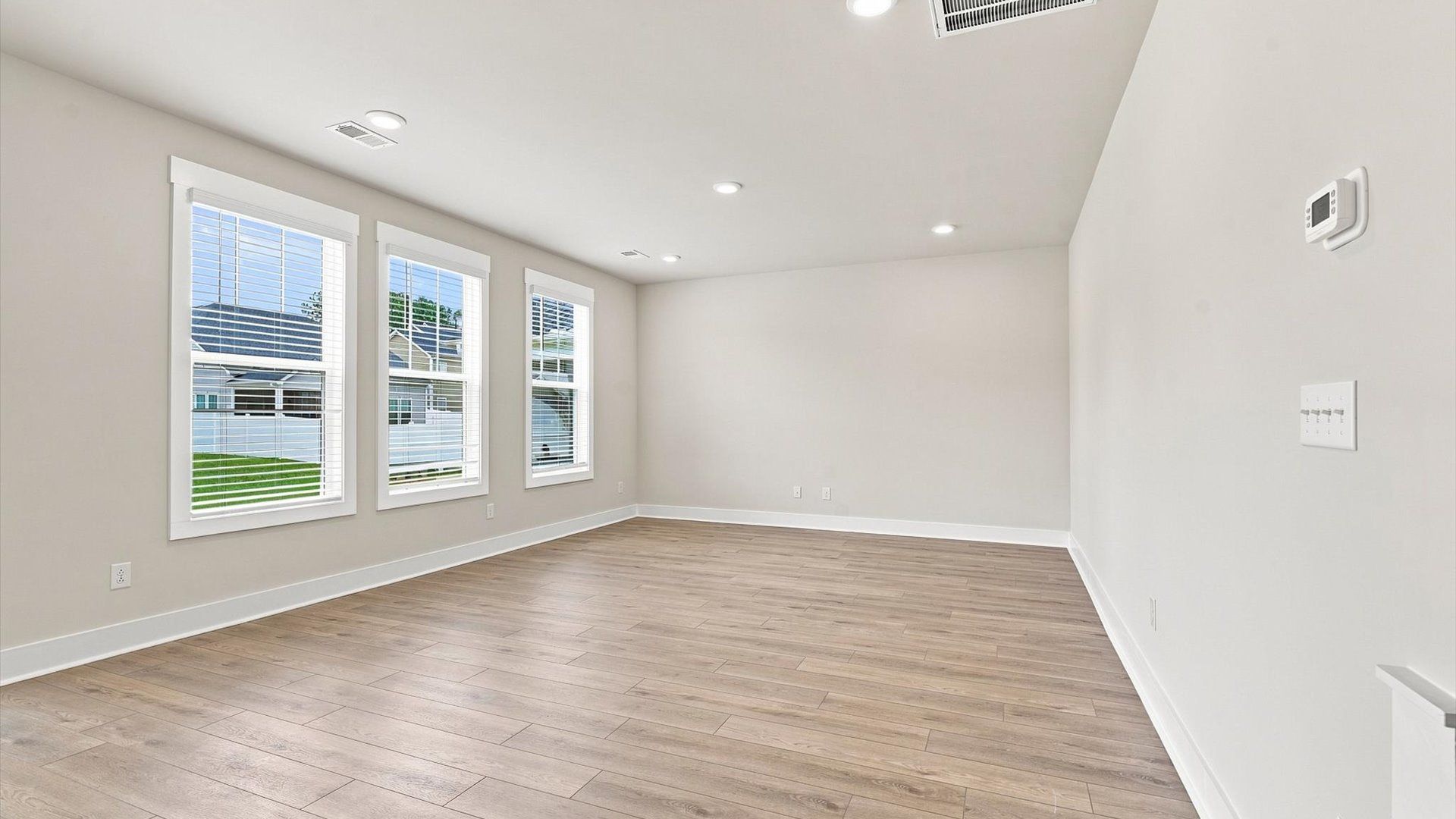 Vibrant and welcoming family room anchored by clean lines, tasteful materials, and abundant light in Inman, SC