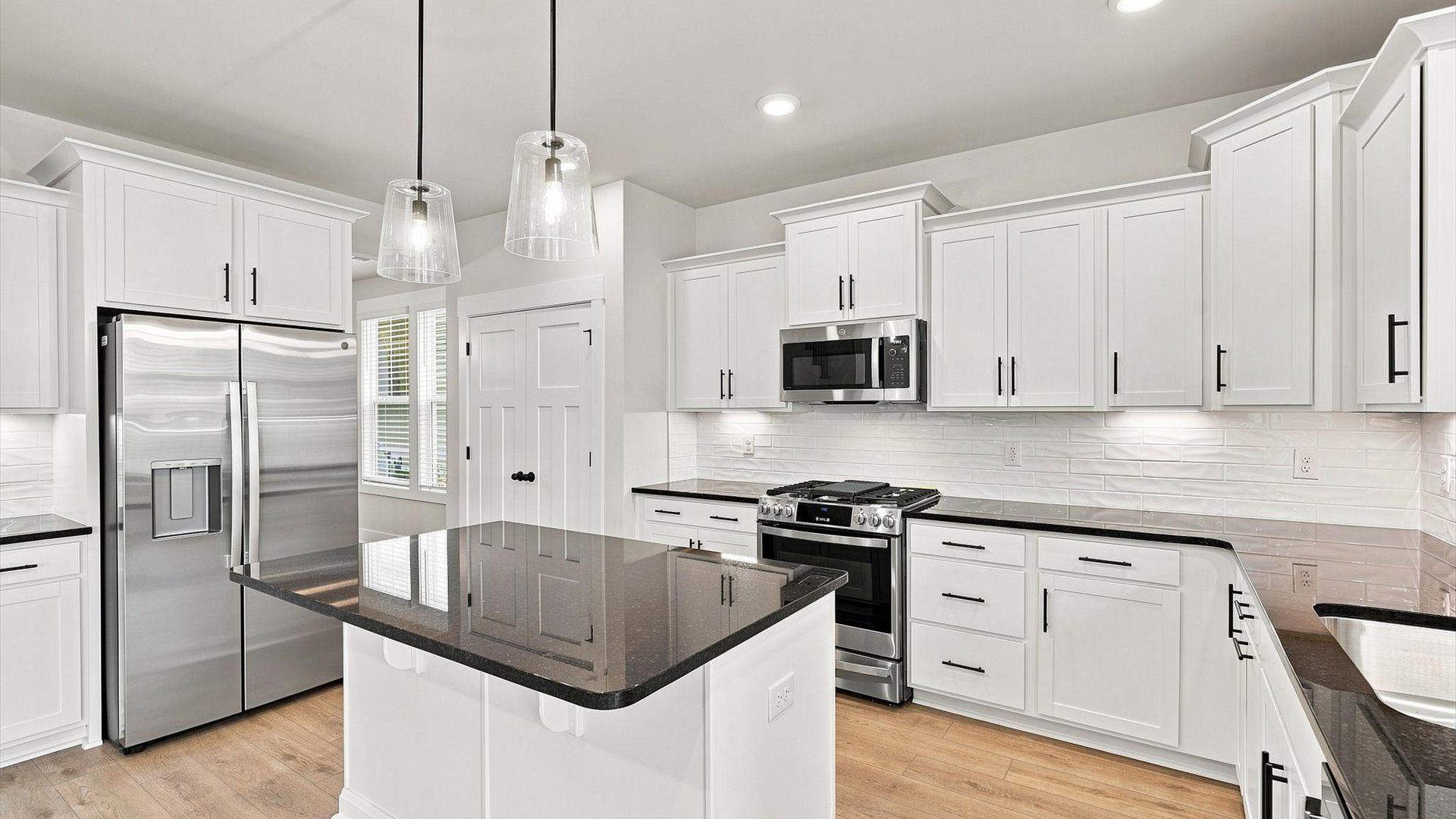 Superior craftsmanship shines in this modern kitchen with a space-saving island and open flow