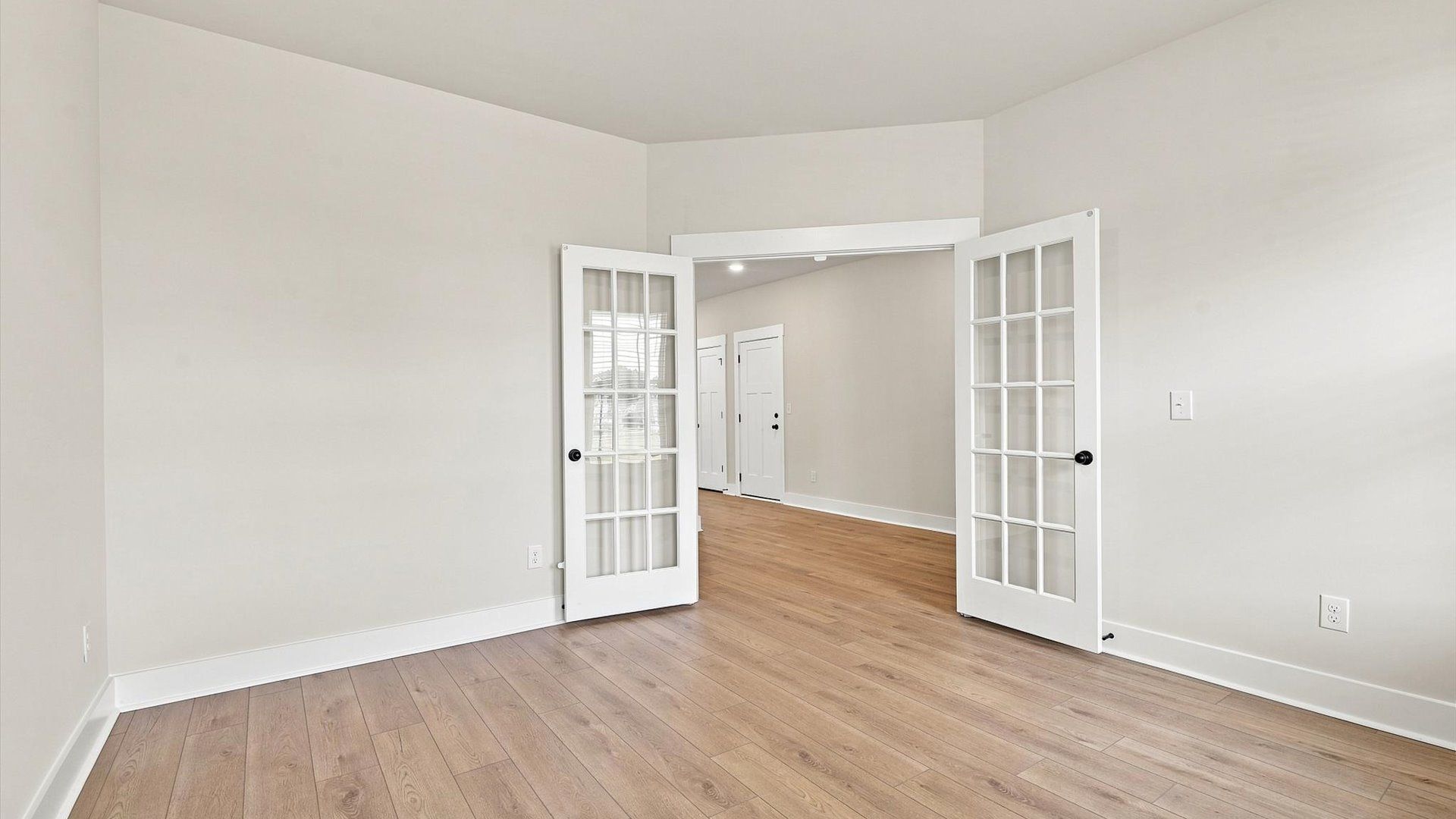 Tasteful French door study offering a quiet, elegant workspace in this vibrant Inman home