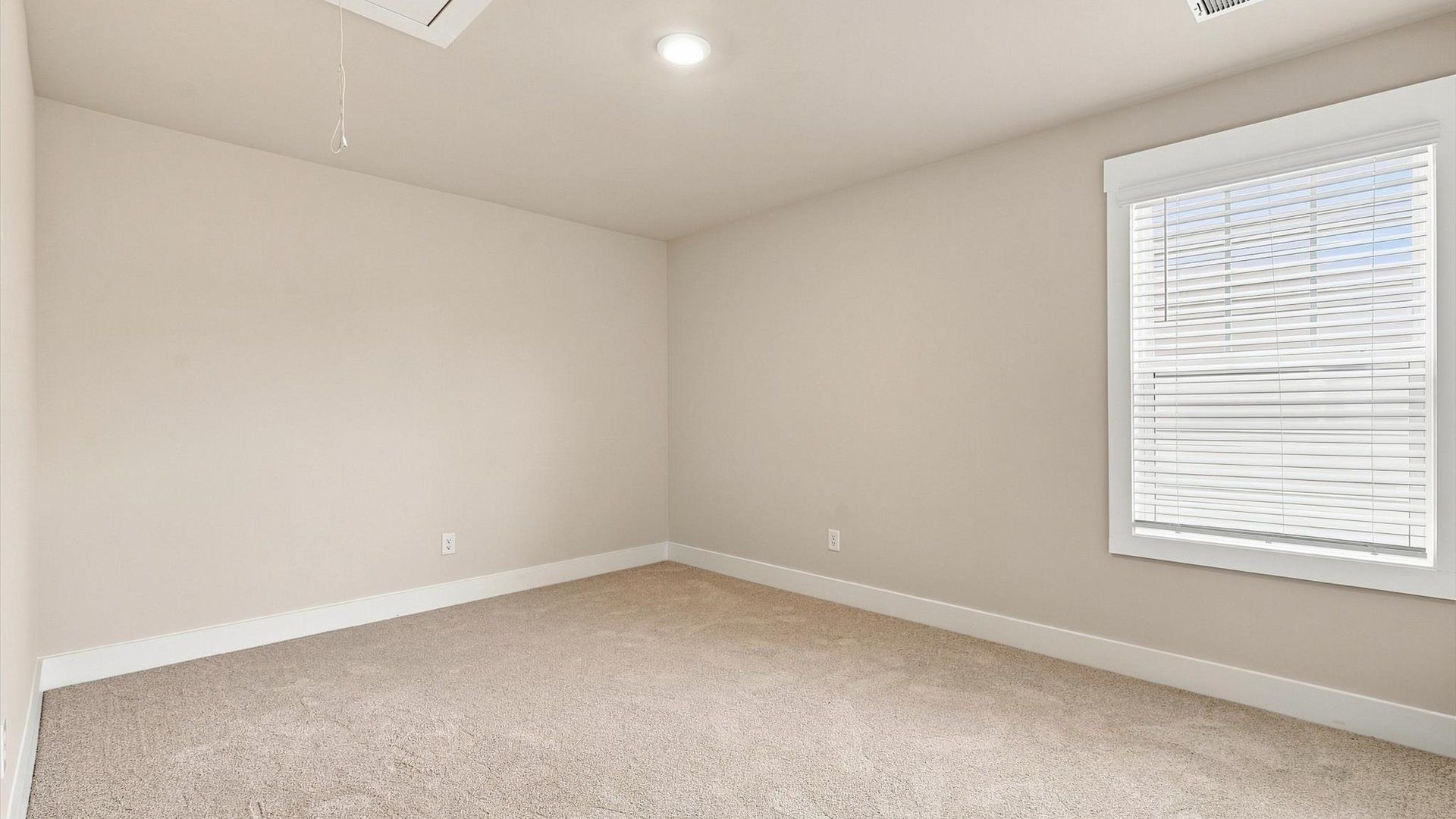 Vibrant and restful bedroom with an oversized window, refined detail, and a warm, welcoming atmosphere by DRB Homes