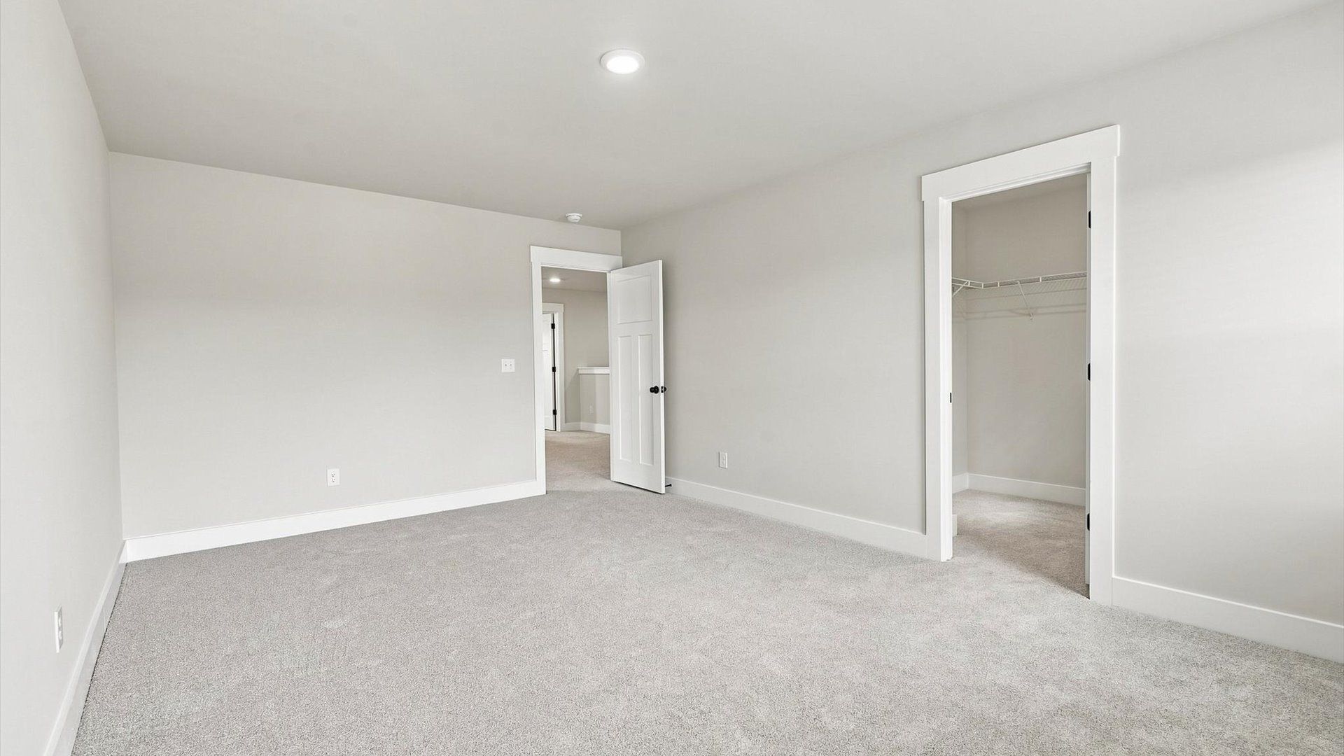 First-class secondary bedroom with comfortable carpeted flooring and generous closet space by DRB Homes