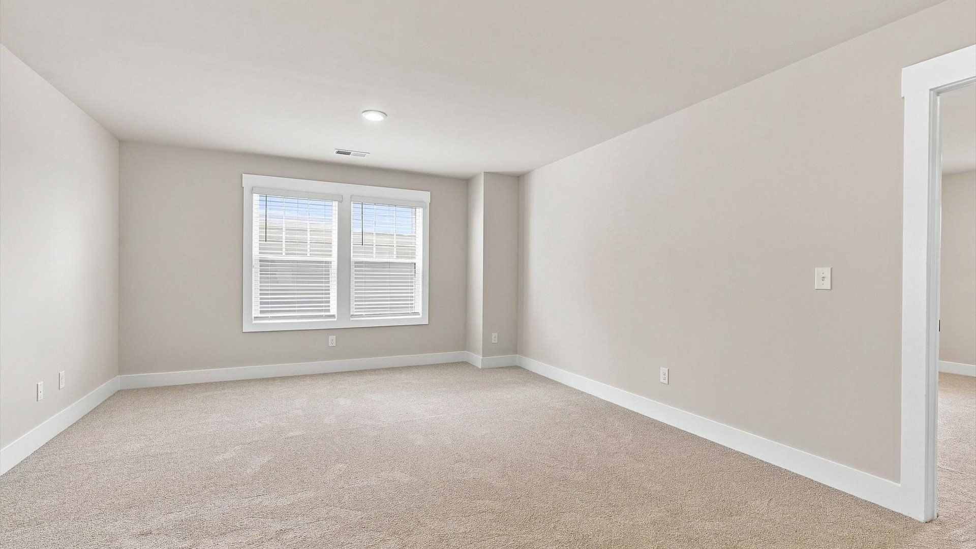 Vibrant loft with carpet flooring and flexible space for work, play, or relaxing located in Inman, SC