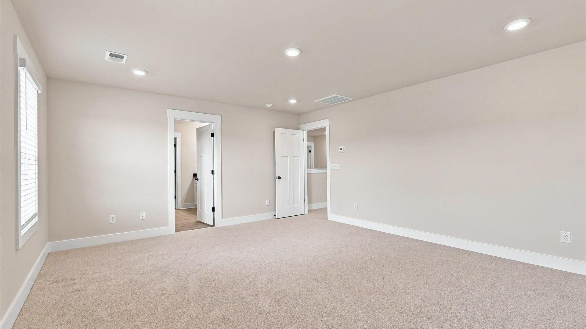 Elegant primary suite with tray ceiling and walk-in closet in this top-notch Walnut Ridge home