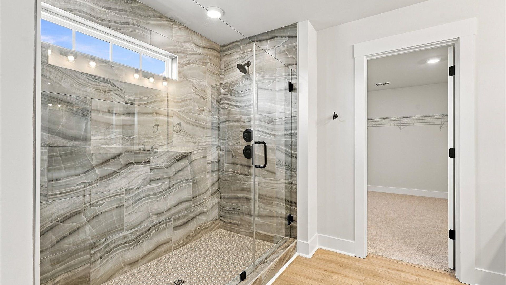 Superior en-suite primary bathroom with a stylish walk-in shower—crafted with high standards in mind by DRB Homes