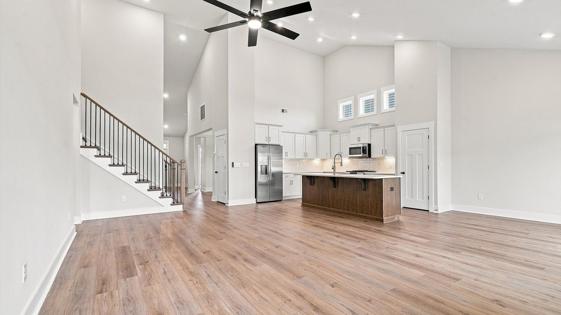 Vibrant family room with high-impact two-story ceilings and thoughtful layout for entertaining in Inman, SC