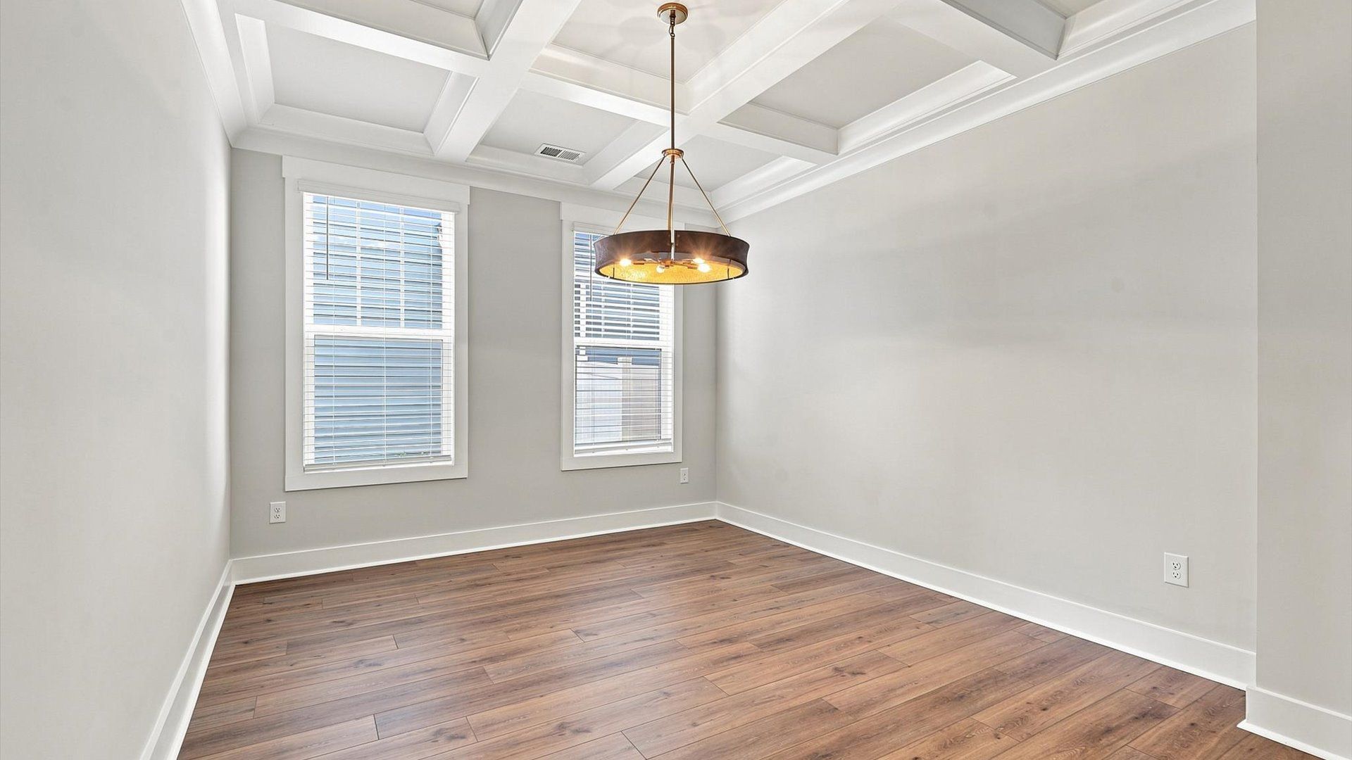 Dining room with coffered ceiling detail that adds warmth and architectural character
