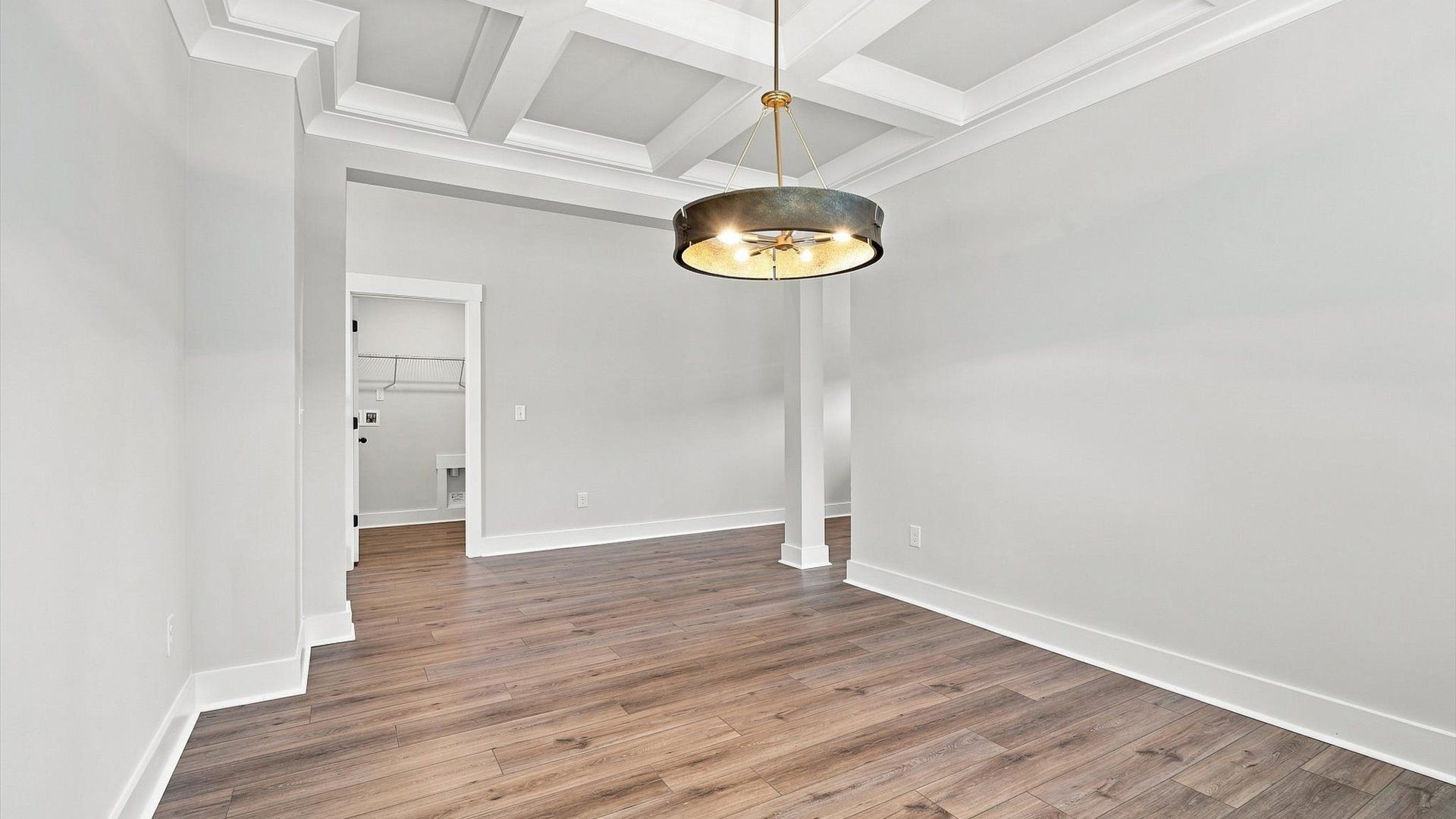 Tasteful coffered ceiling highlights the high standards of this vibrant DRB Homes dining room