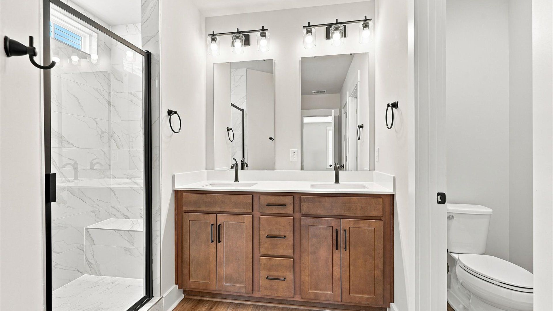 Exceptional en-suite with dual vanity and glass-enclosed walk-in shower for superior everyday comfort at Walnut Ridge