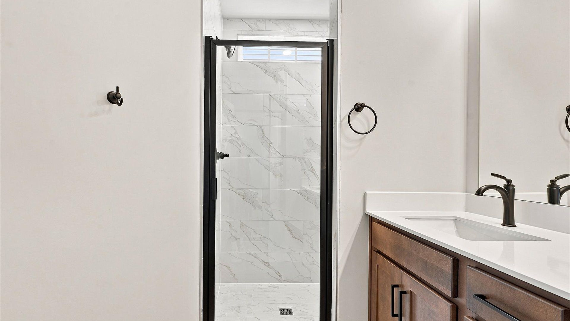 Notable primary bath featuring a walk-in shower and tasteful design touches throughout by DRB Homes