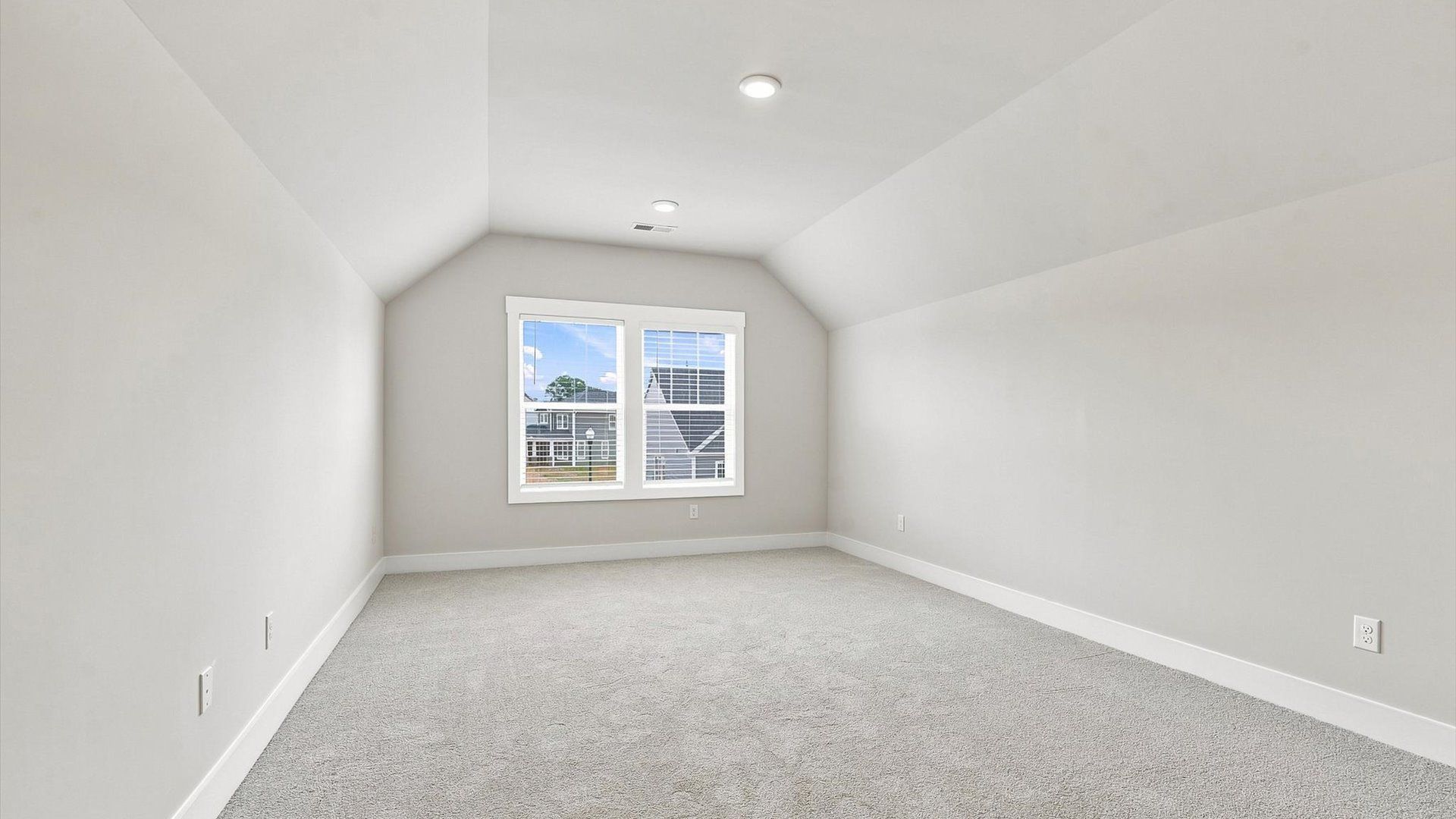 Top-notch design defines this bonus room with carpeted floors and an open, airy layout in Inman, SC