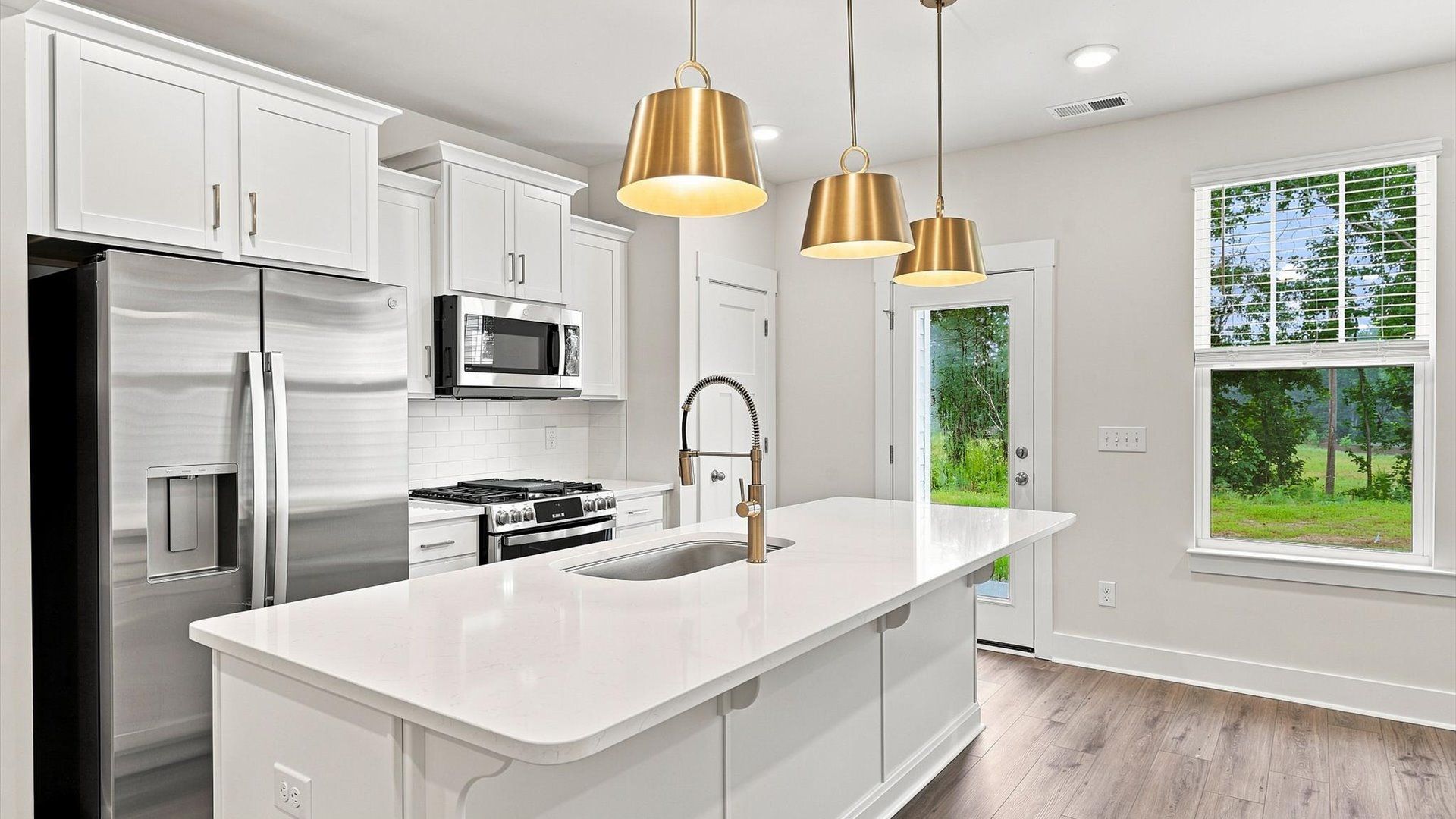 First-class finishes and a thoughtfully scaled island highlight this elegant kitchen space at Ransdell Pointe