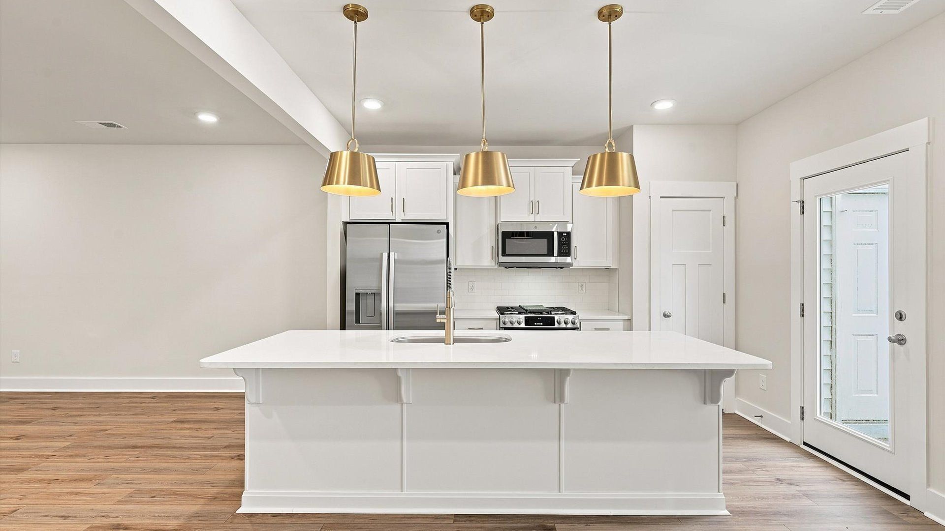 Vibrant kitchen layout with a center island, refined finishes, and open-concept flow at Ransdell Pointe
