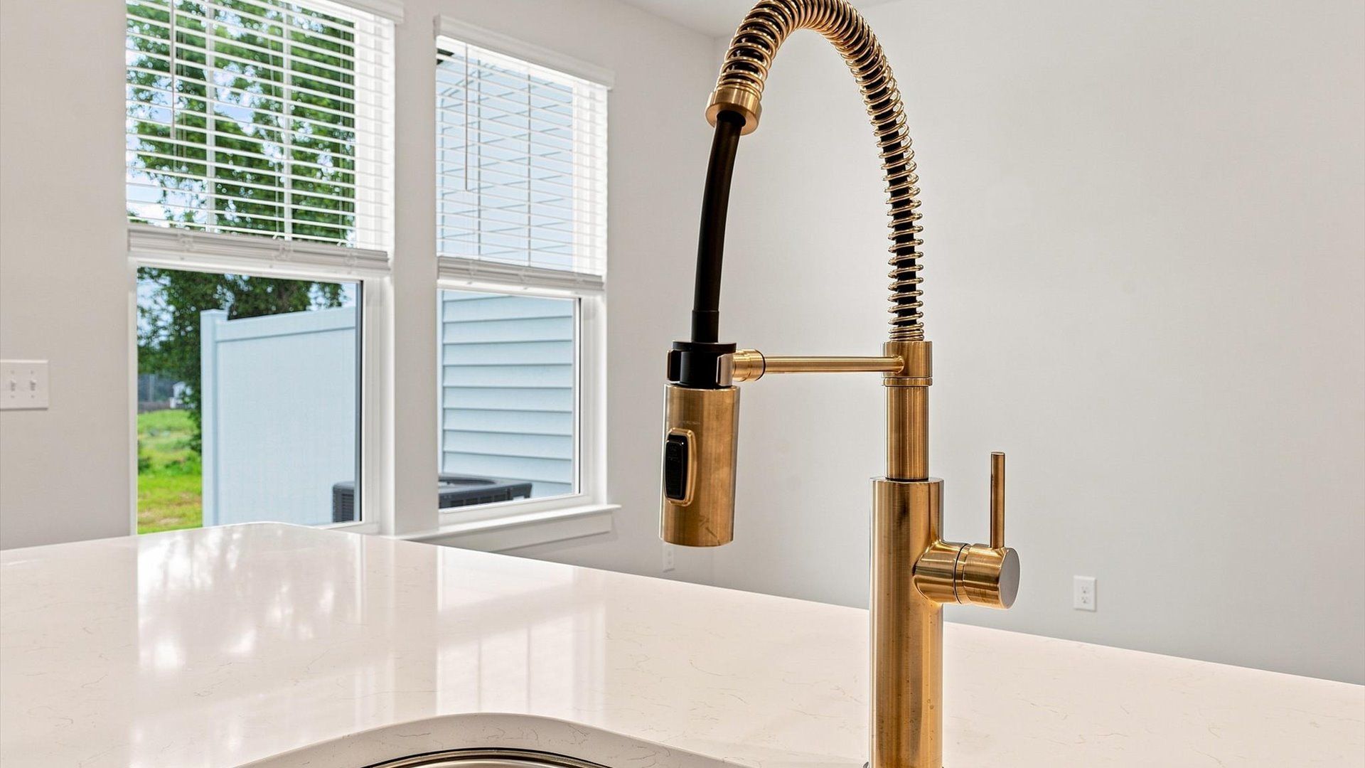 Bright and welcoming kitchen with carefully selected finishes and quartz countertops at Ransdell Pointe
