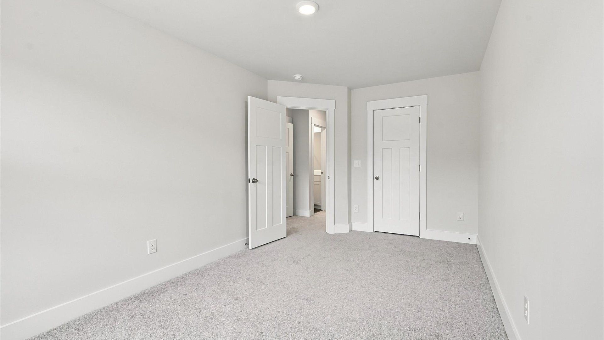 Notable secondary bedroom offering cozy carpeted flooring and a stylish walk-in closet at Ransdell Pointe