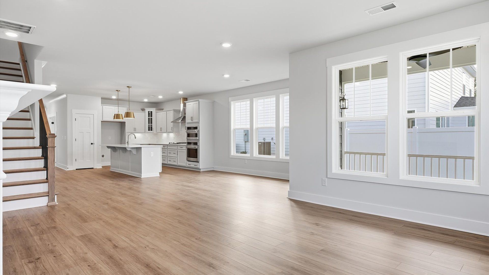 Spacious family room with rich hardwood flooring and elegant trim work in a reputable DRB Homes build