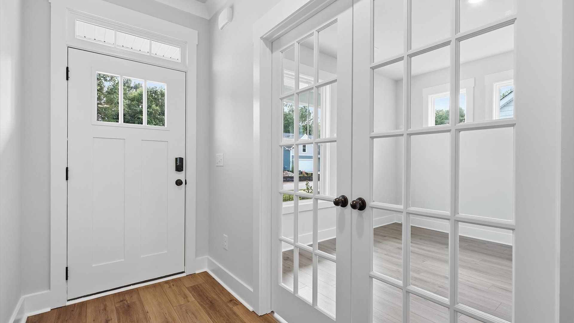 Stylish foyer with hardwood flooring and tasteful architectural detail in a superior layout