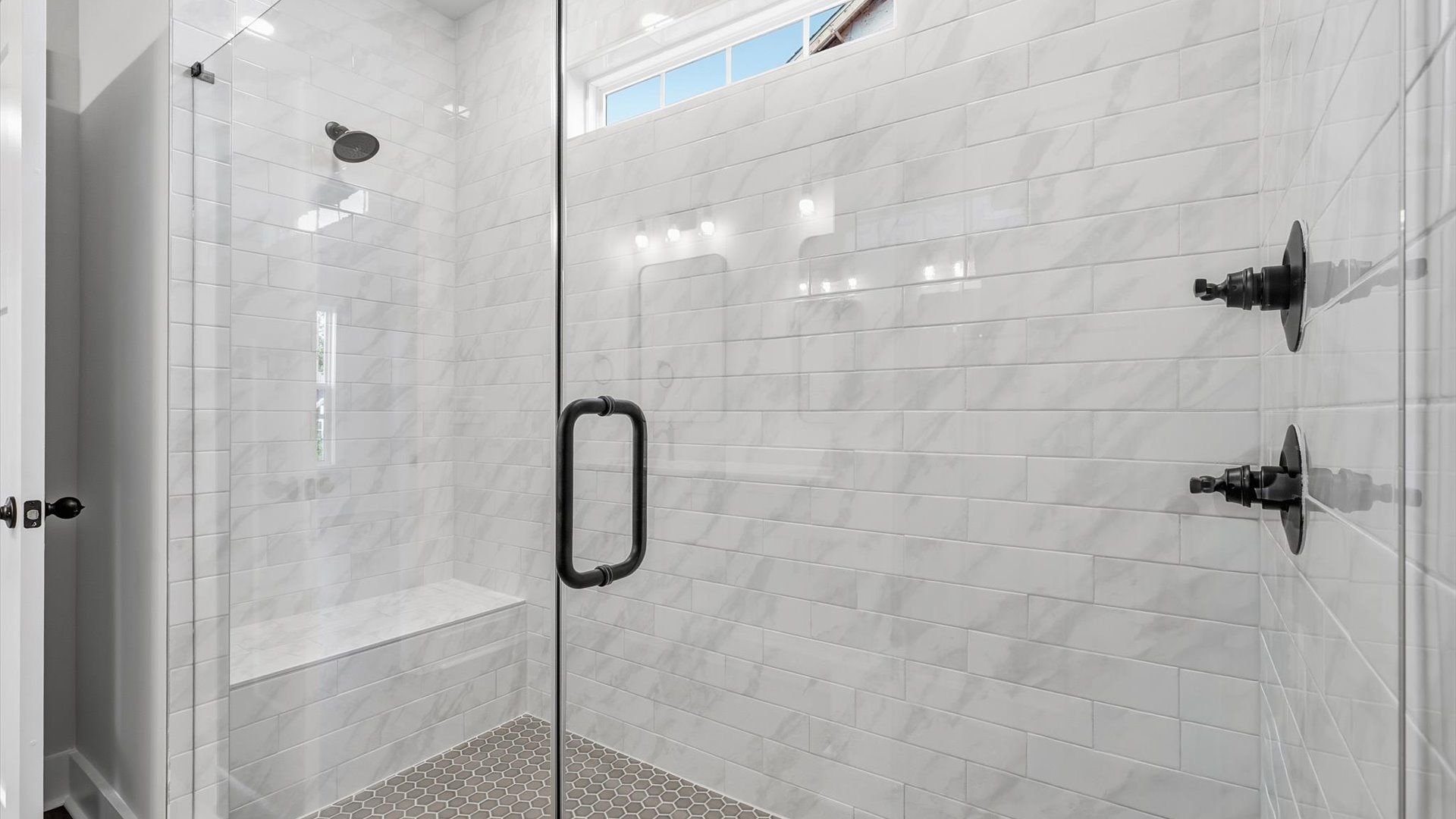 Memorable mornings begin in this elegant primary bathroom with walk-in shower and double vanity near Lake Hartwell