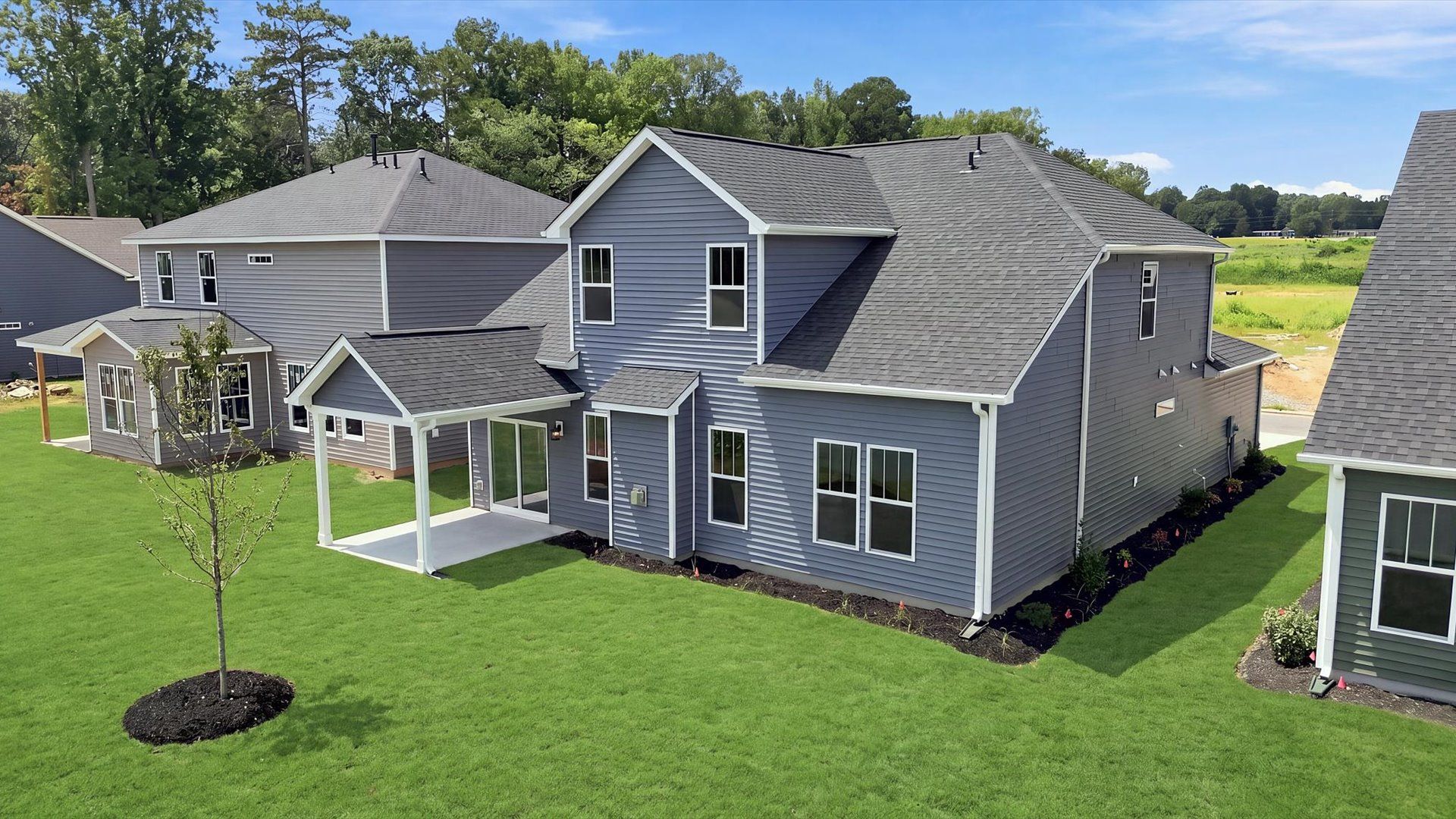 Vibrant rear outdoor space featuring a covered porch and exceptional craftsmanship located in Woodruff, SC
