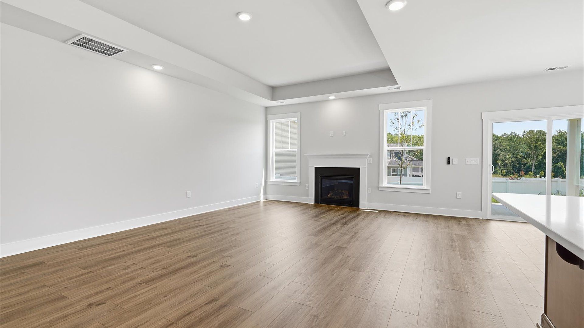 Hardwood flooring and high standards define this vibrant family room ideal for everyday living at Harrier Point