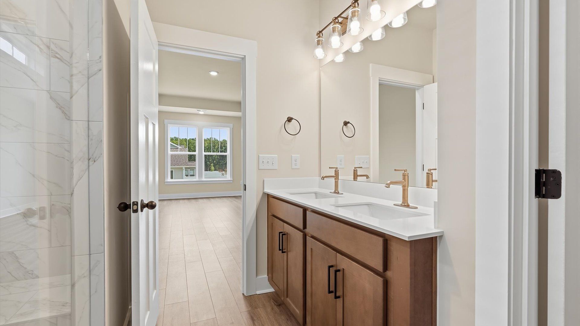 Spacious and modern primary bathroom with walk-in shower and first-class double vanity setup in Woodruff, SC