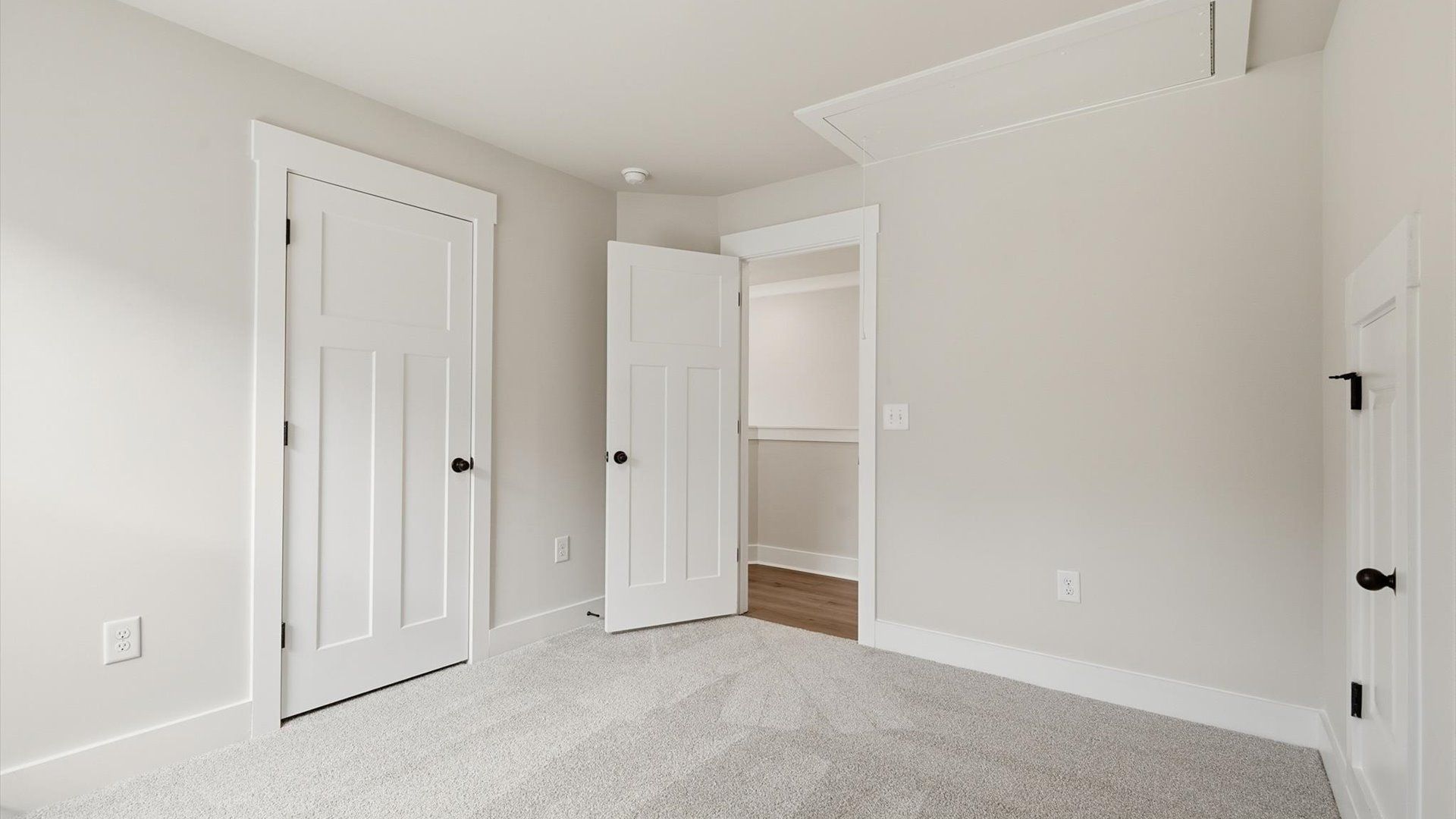 Elegant bedroom retreat featuring soft carpeting and a thoughtfully designed walk-in closet by DRB Homes