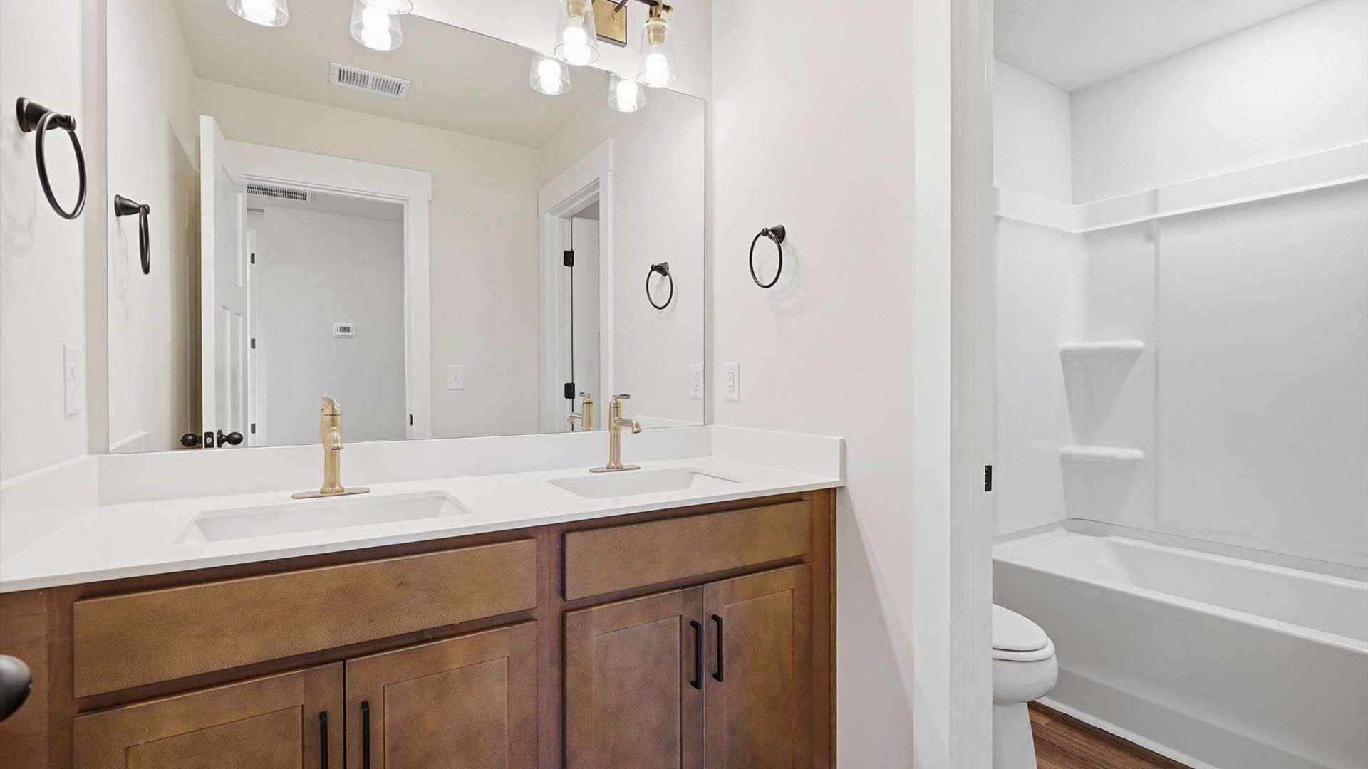 Top-notch bathroom with current fixtures, tasteful materials, and elevated charm at the Harrier Point community