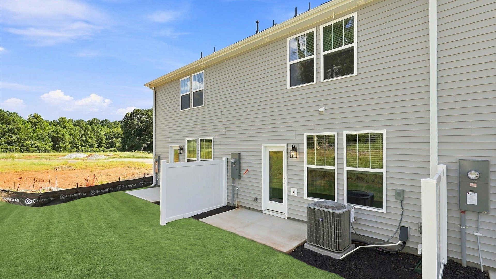 Exceptional outdoor living begins with a spacious patio in this thoughtfully designed home at Clarke Townes
