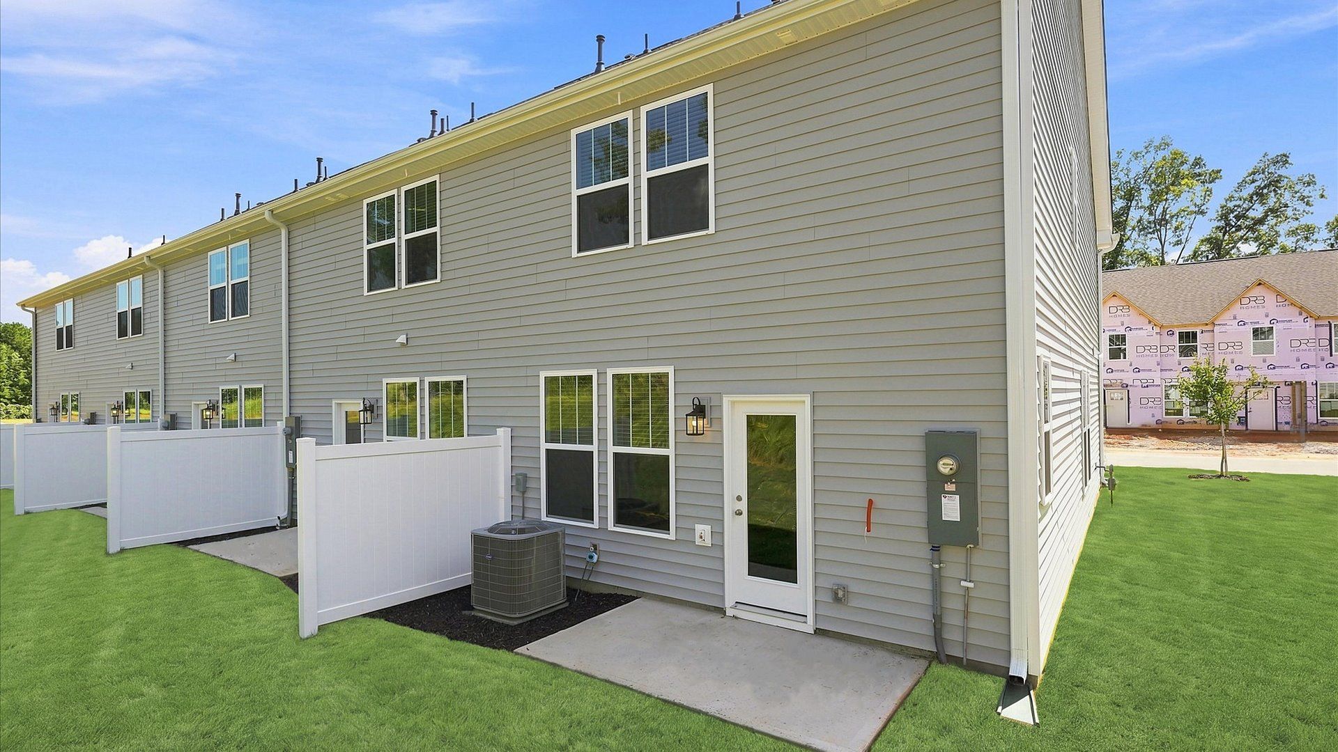 Vibrant rear exterior space featuring a patio and exceptional craftsmanship by DRB Homes