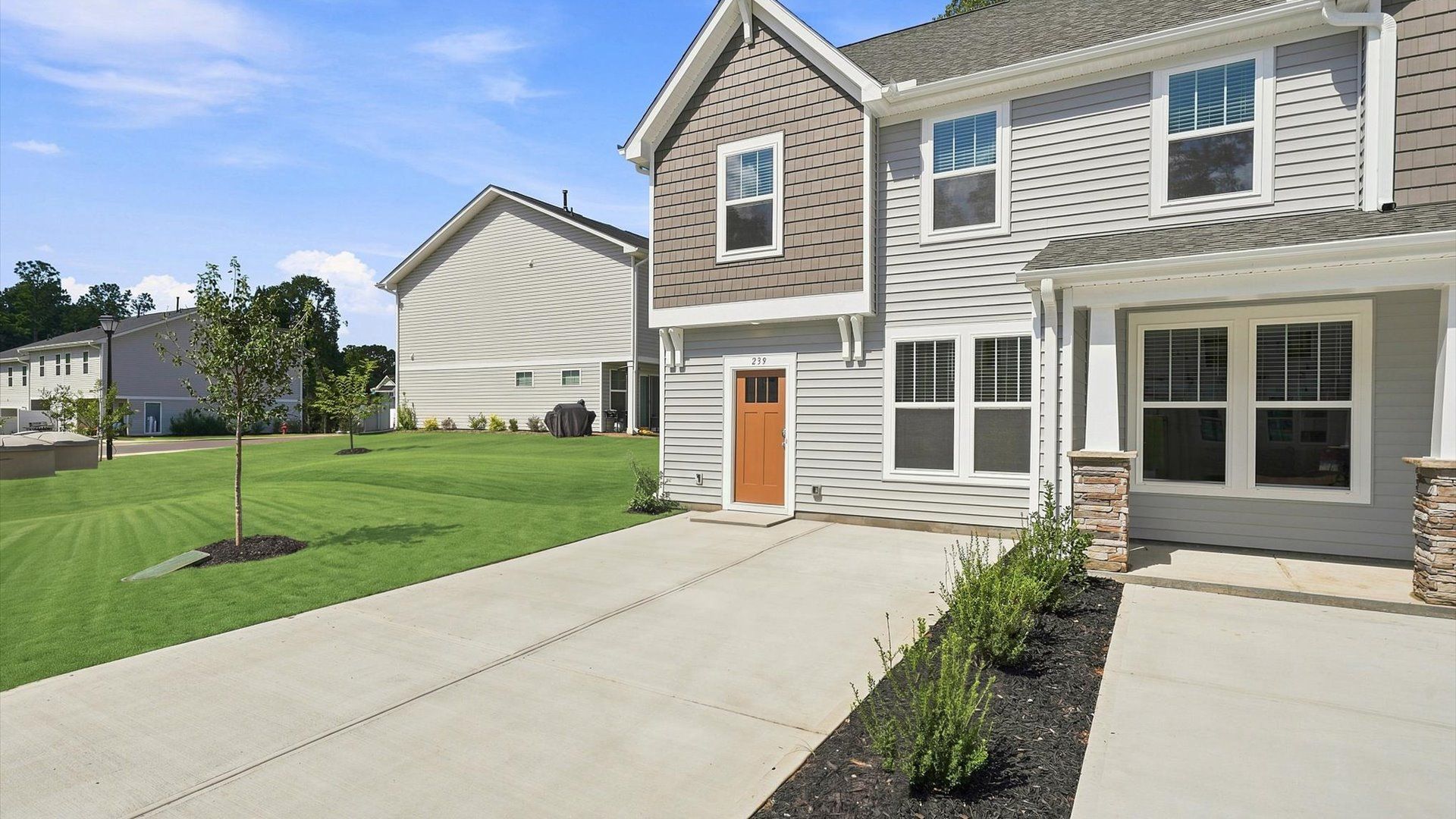 Exceptional end-unit villa with tasteful exterior finishes and a thoughtfully designed façade