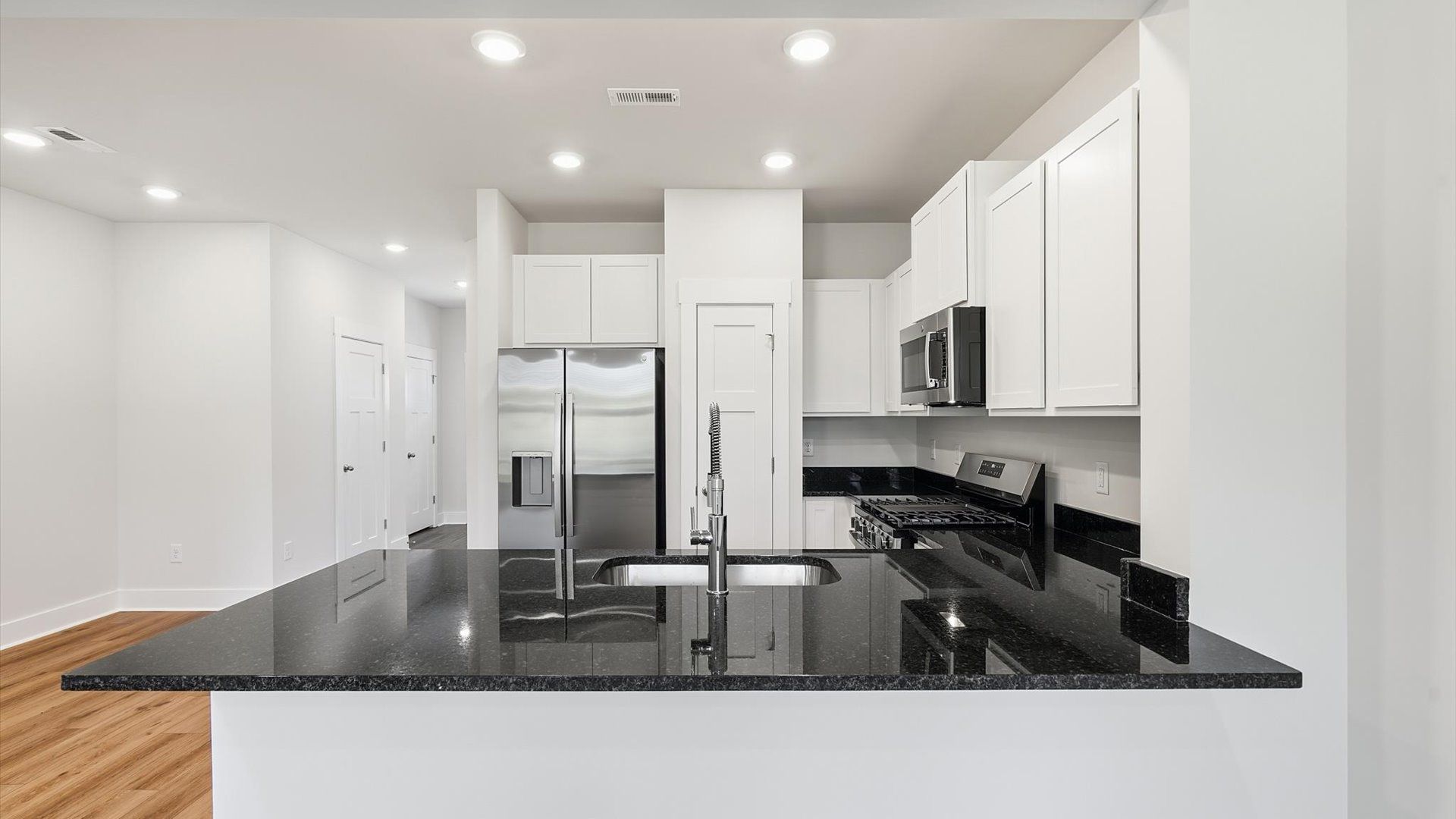 Tasteful kitchen with a streamlined island and modern finishes in a first-class DRB Homes design