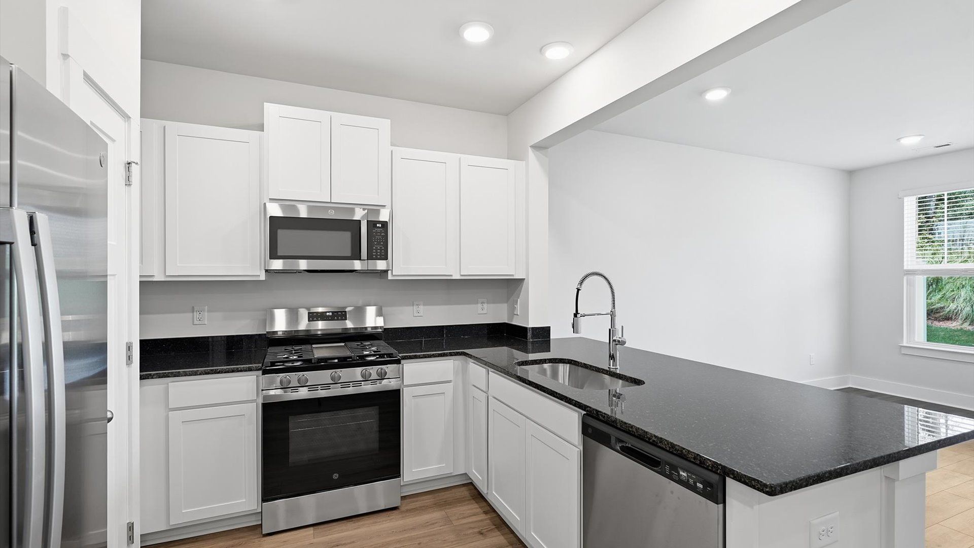 Bright and airy culinary space with generous prep areas and contemporary lighting at Clarke Townes