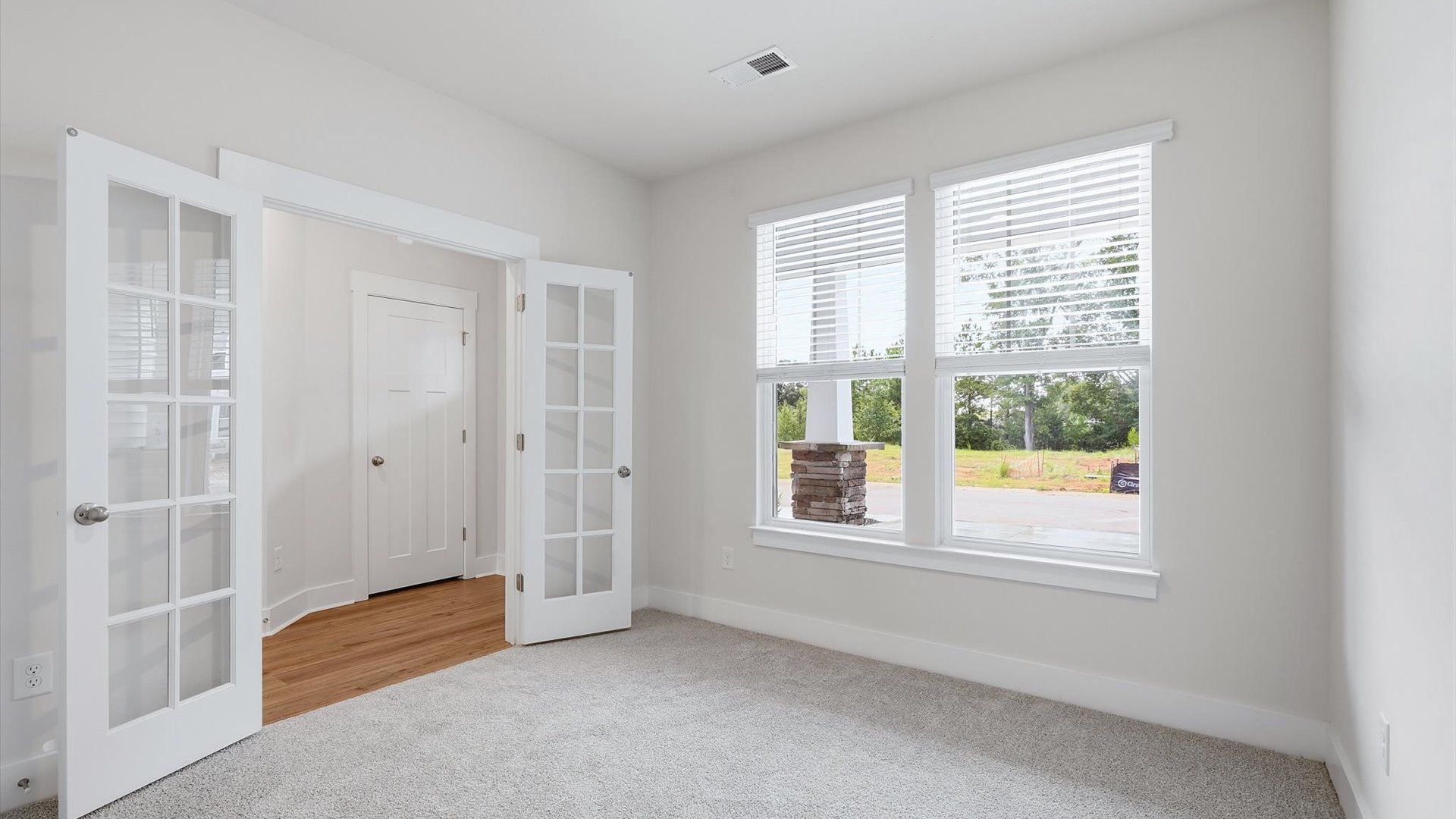 Tasteful French door study offering a quiet, elegant workspace in this vibrant Anderson home