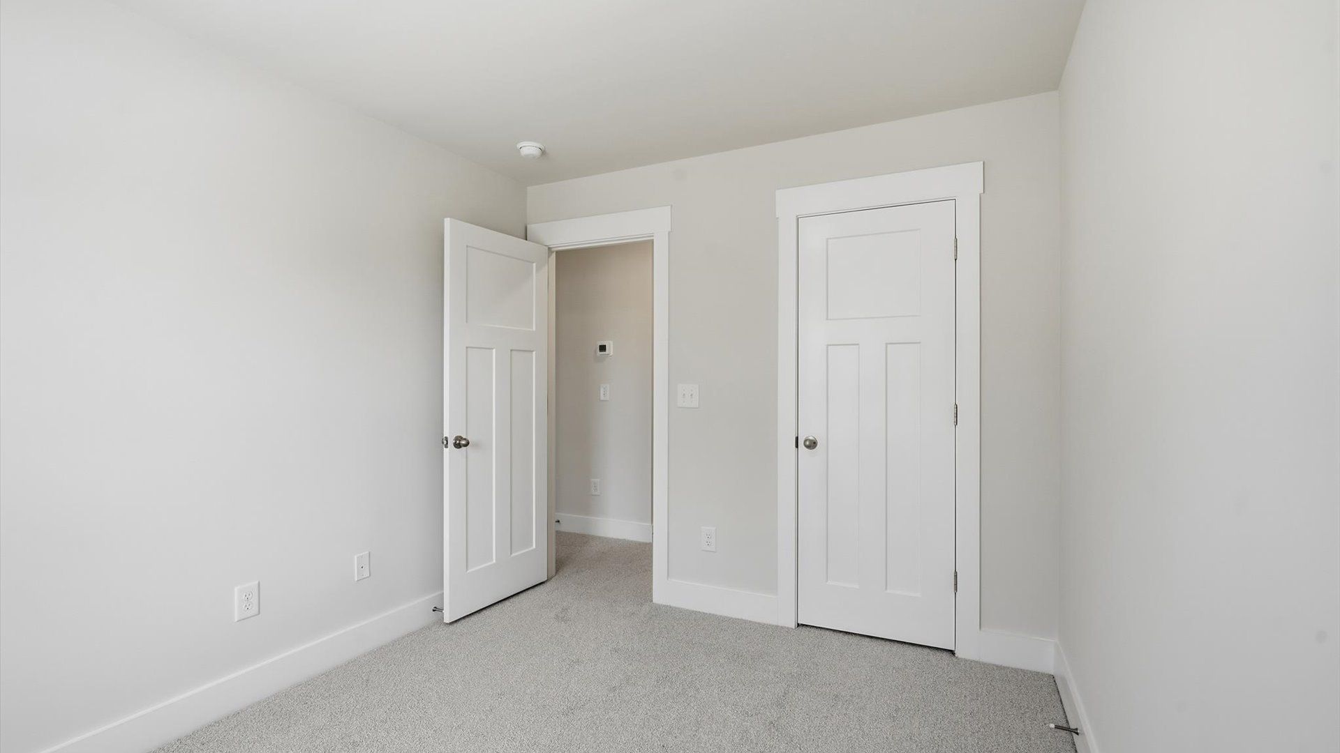 Elegant bedroom retreat featuring soft carpeting and a thoughtfully designed walk-in closet in Anderson, SC