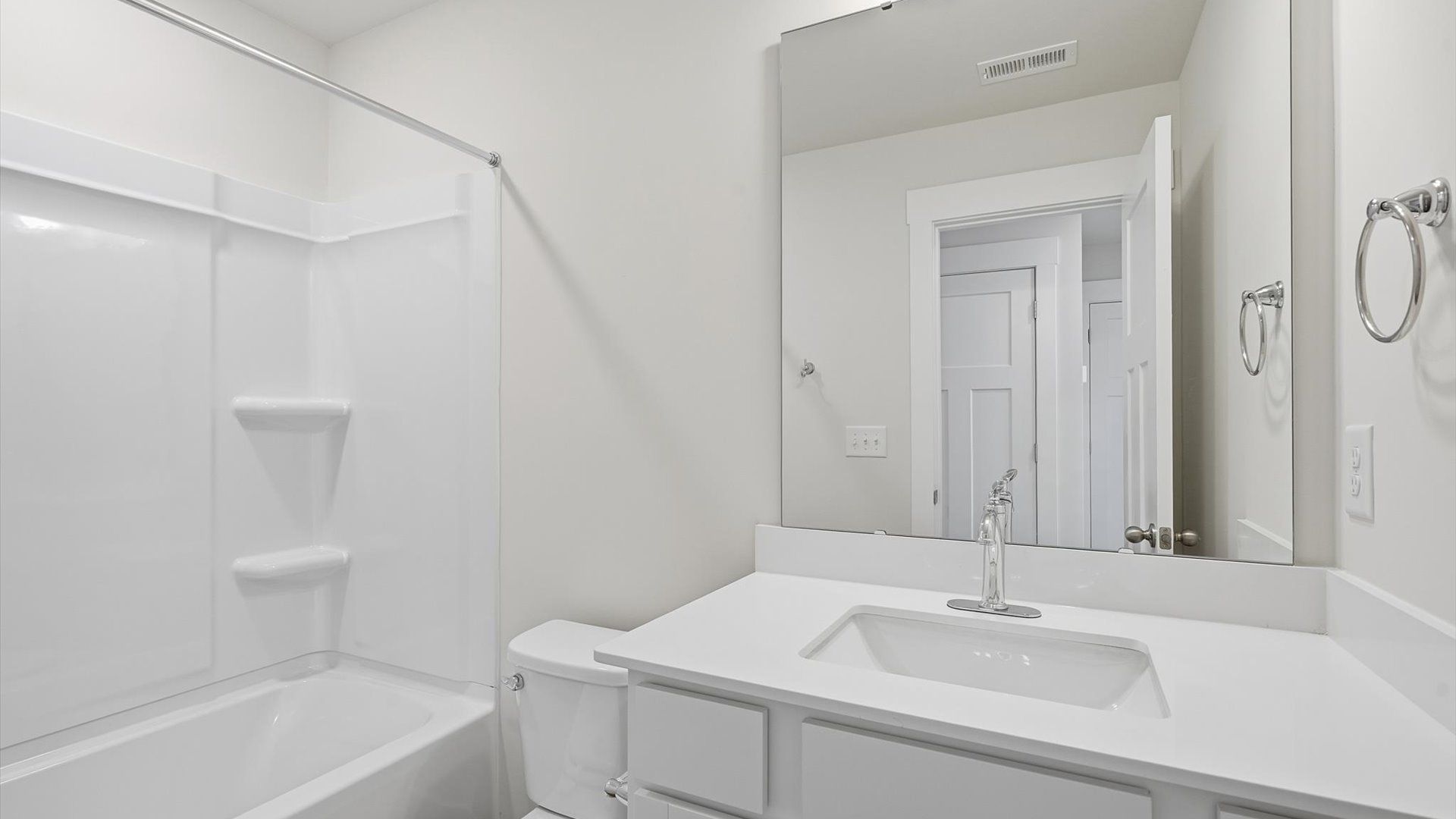 Accomplished bathroom design with sleek tile, high-quality cabinetry, and refined hardware at Clarke Townes