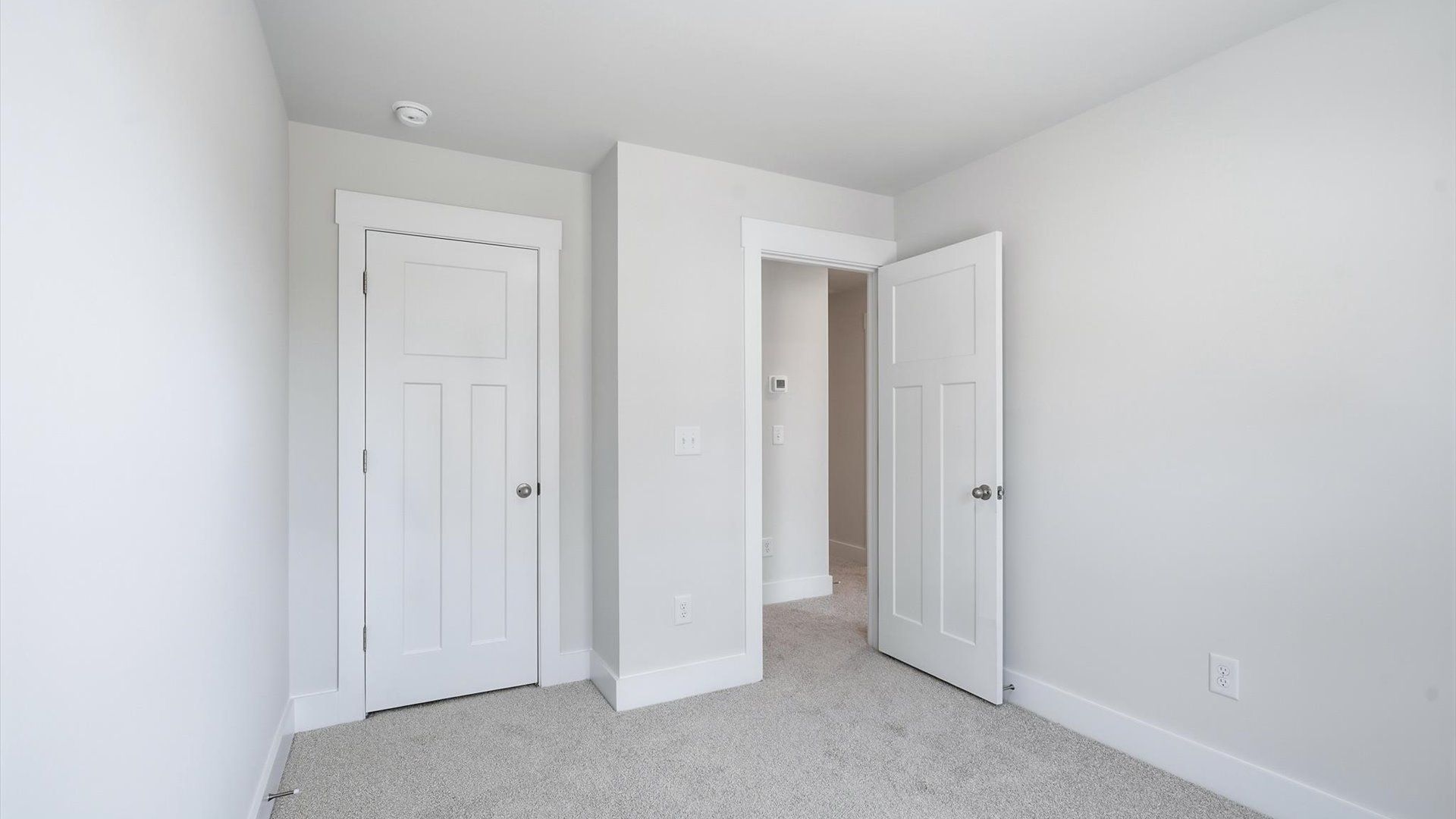 Superior comfort in a secondary bedroom with plush carpet and an oversized walk-in closet near Lake Hartwell