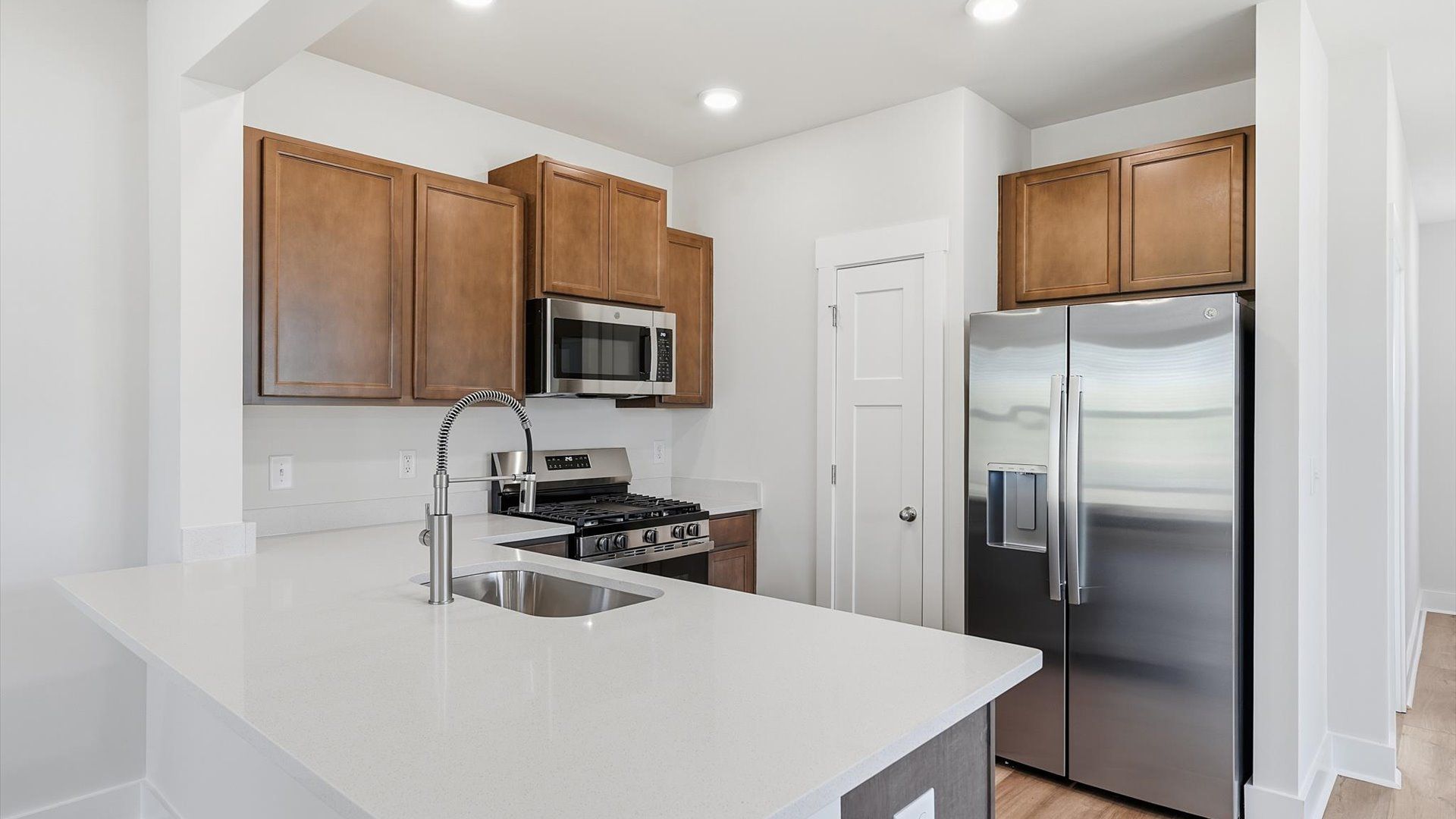 Accomplished design in a kitchen that blends function and form with a right-sized island at Clarke Townes