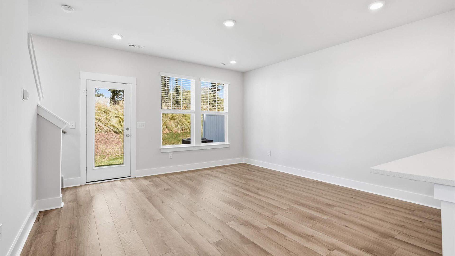 Spacious family room with rich hardwood flooring and elegant trim work in a reputable DRB Homes build