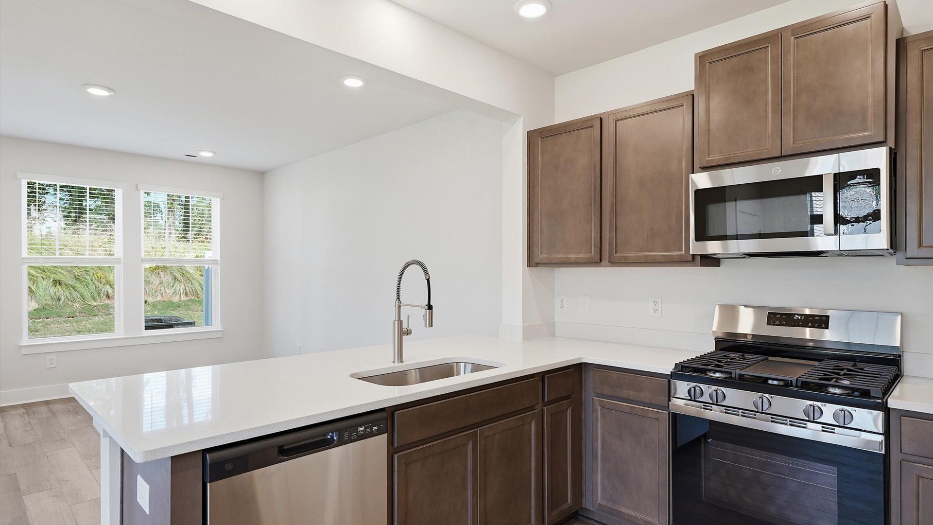 Well-designed kitchen with stainless steel appliances and tasteful finishes that elevate everyday living at Clarke Townes