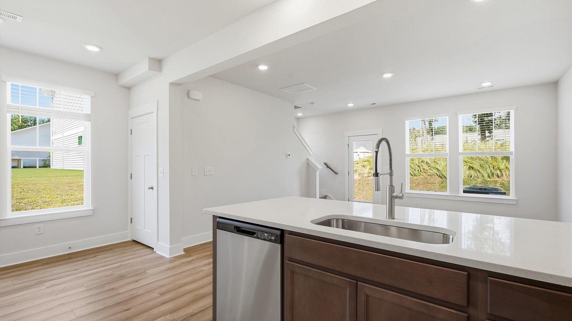 Highly skilled craftsmanship shines in this modern kitchen with natural light and a central island focal point