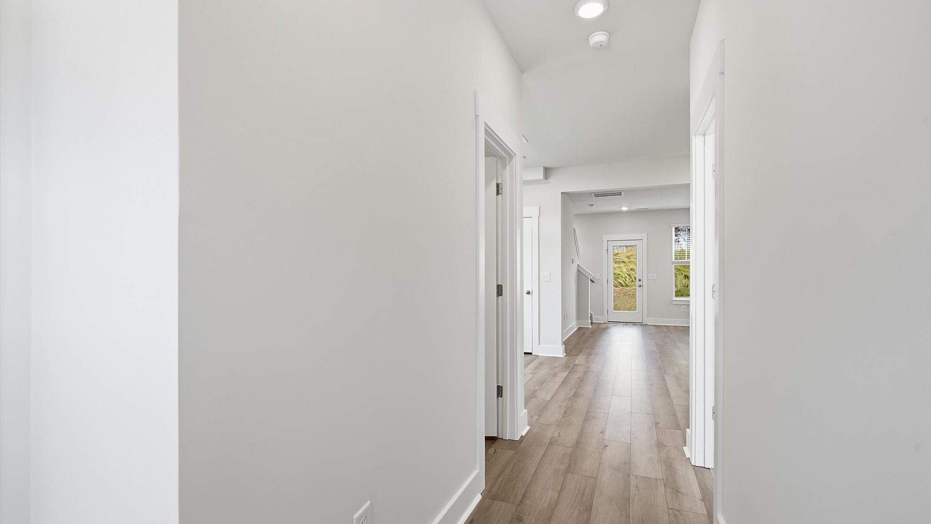 Refined foyer with hardwood floors and thoughtful design for a first-rate welcome