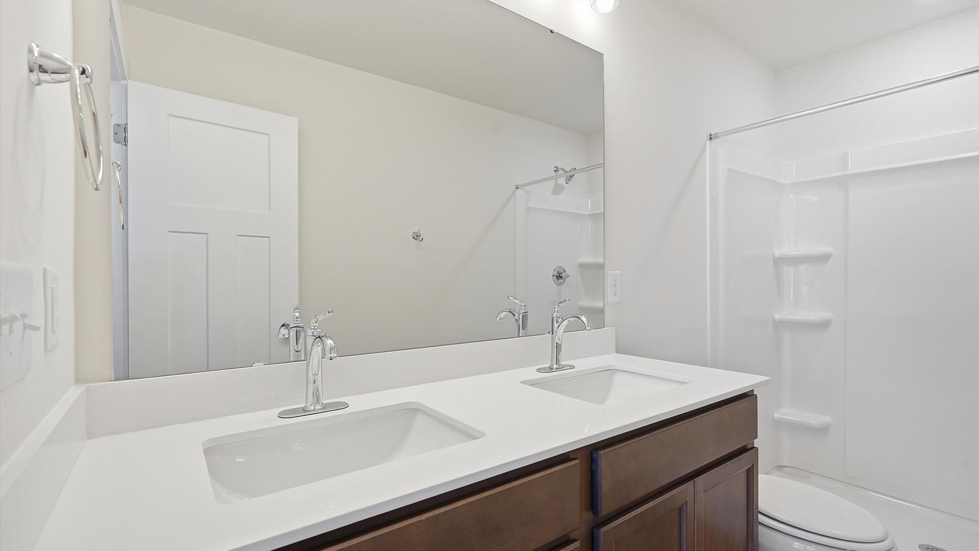 Spacious and modern primary bathroom with walk-in shower and first-class double vanity setup at Clarke Townes
