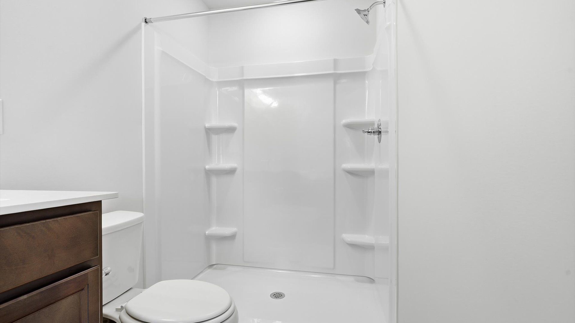 Notable primary bath featuring dual vanity, walk-in shower, and tasteful design touches throughout by DRB Homes