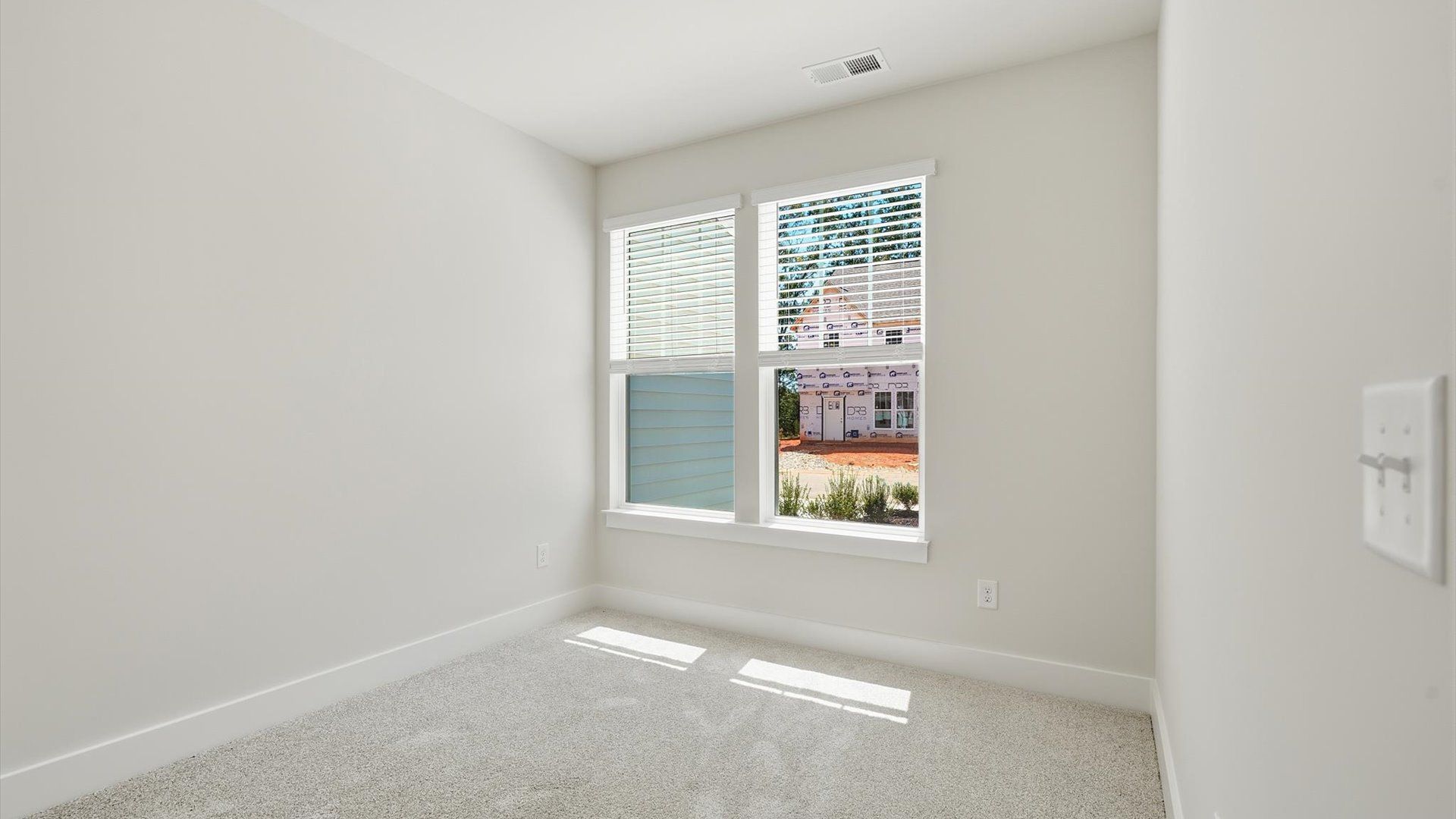 First-rate bedroom with plush carpeting and large windows that provide an open, airy feel near Lake Hartwell