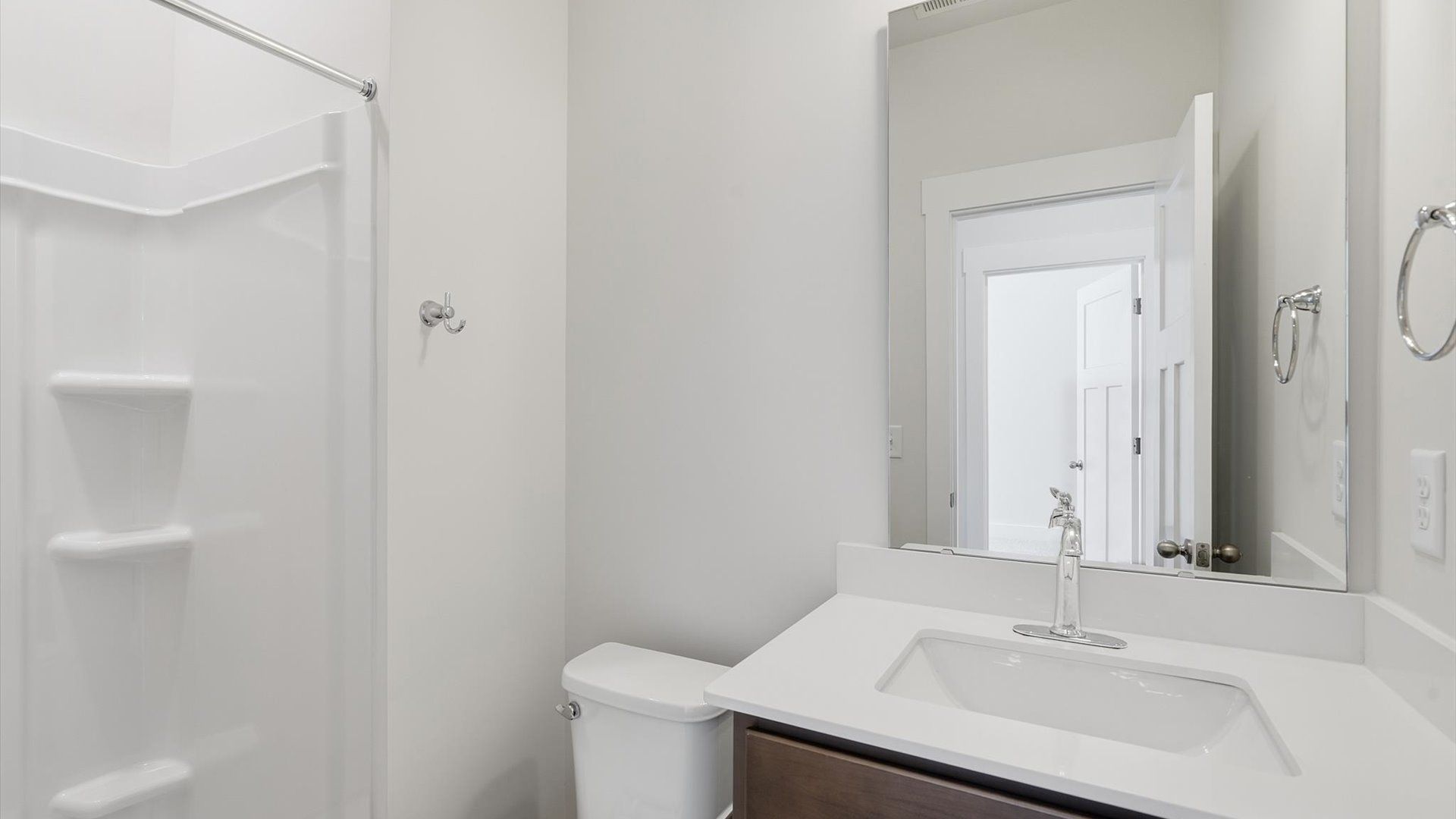 Refined hall bath with elevated finishes and a highly functional layout by DRB Homes