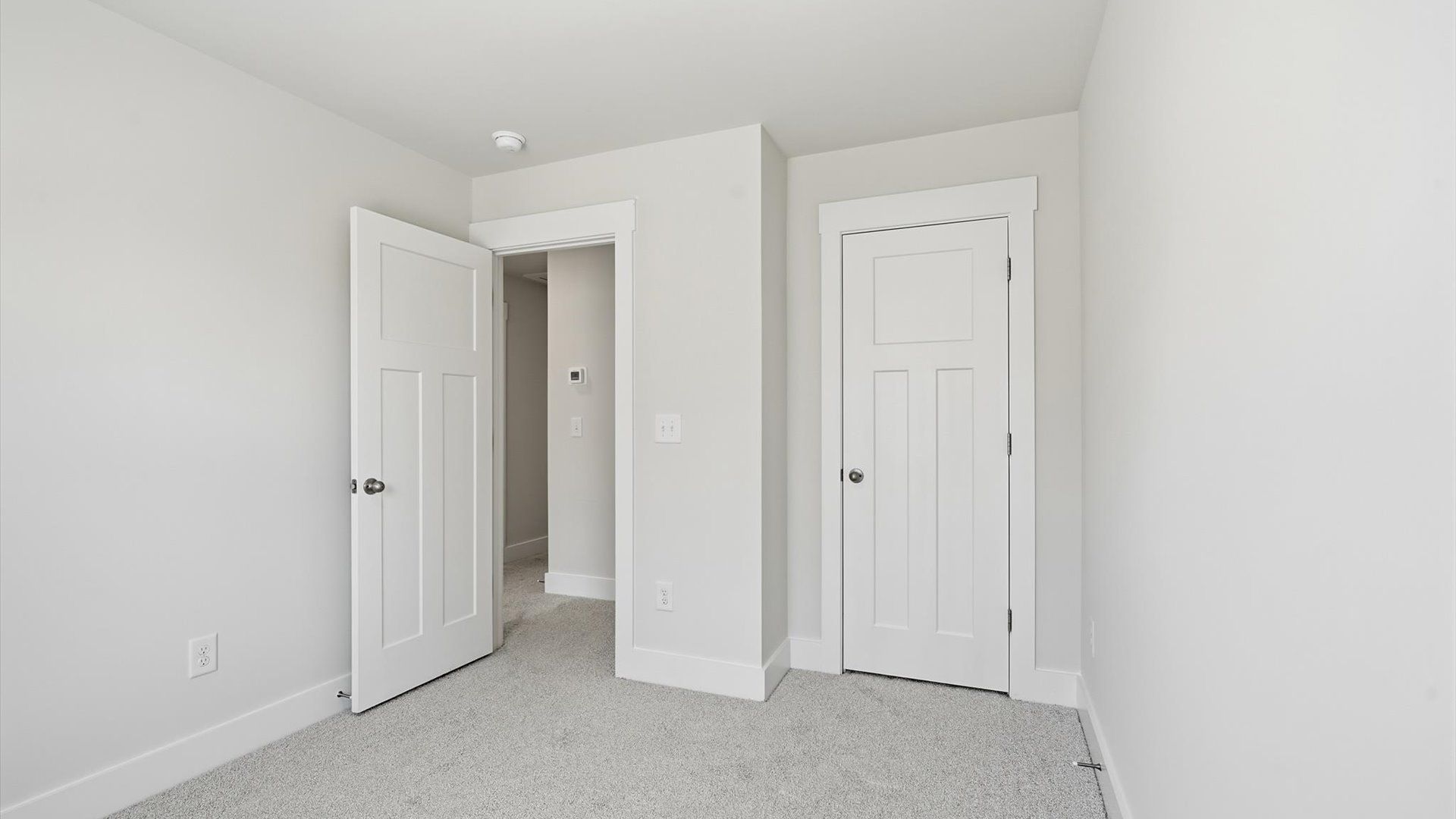 Accomplished design shines in this carpeted bedroom with a functional walk-in closet in Anderson, SC
