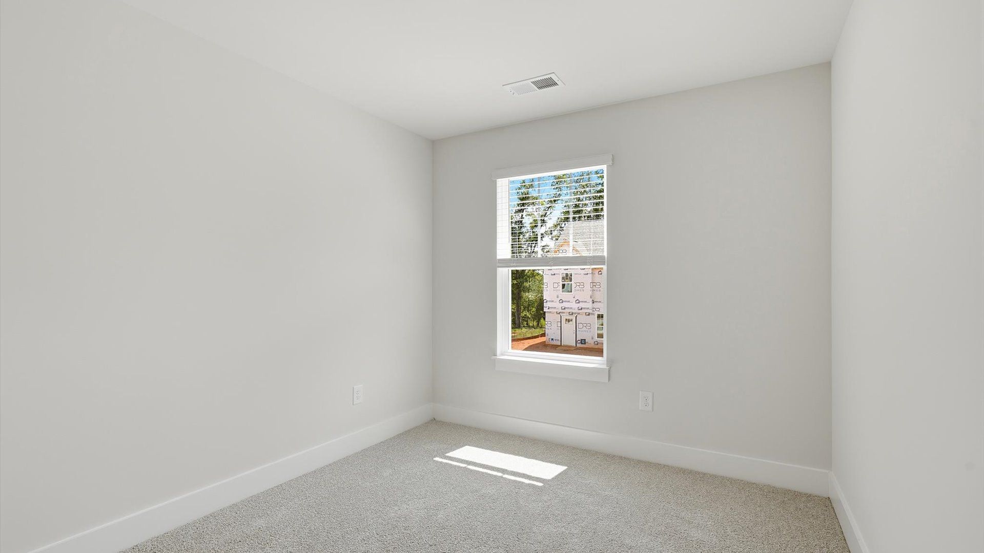 Superior comfort in this light-filled bedroom with plush carpeting and a thoughtfully placed large window